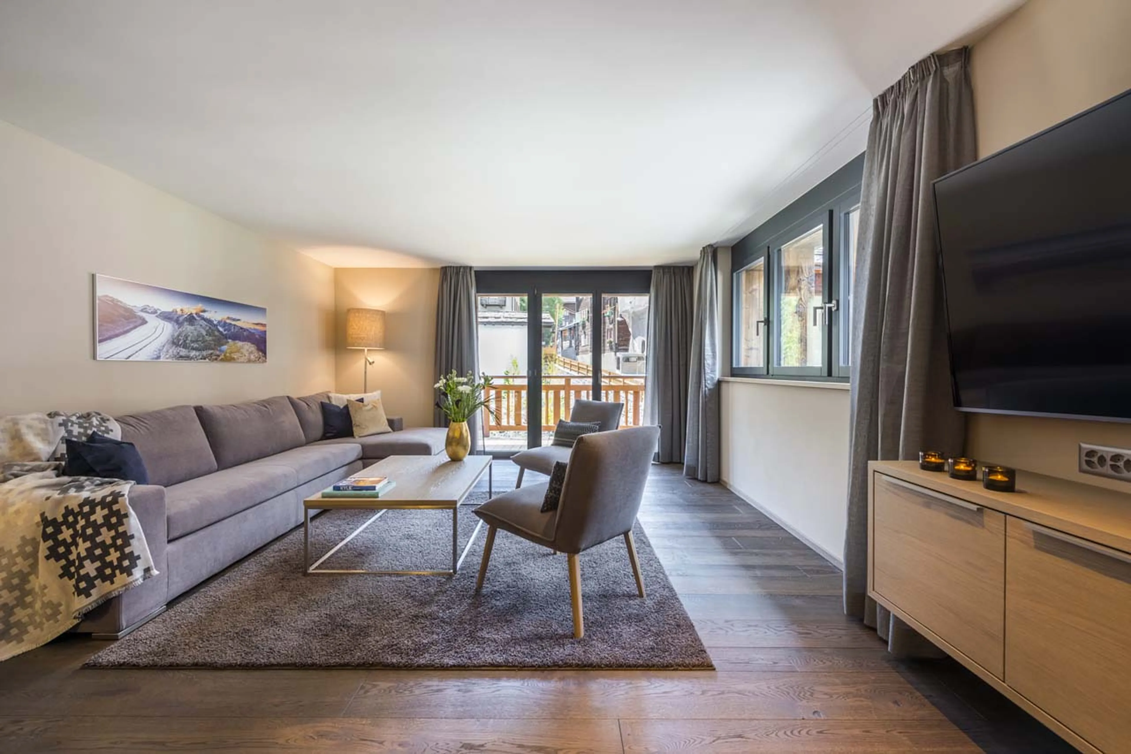 Living area with balcony access at Christiania Apartment 3 in Zermatt