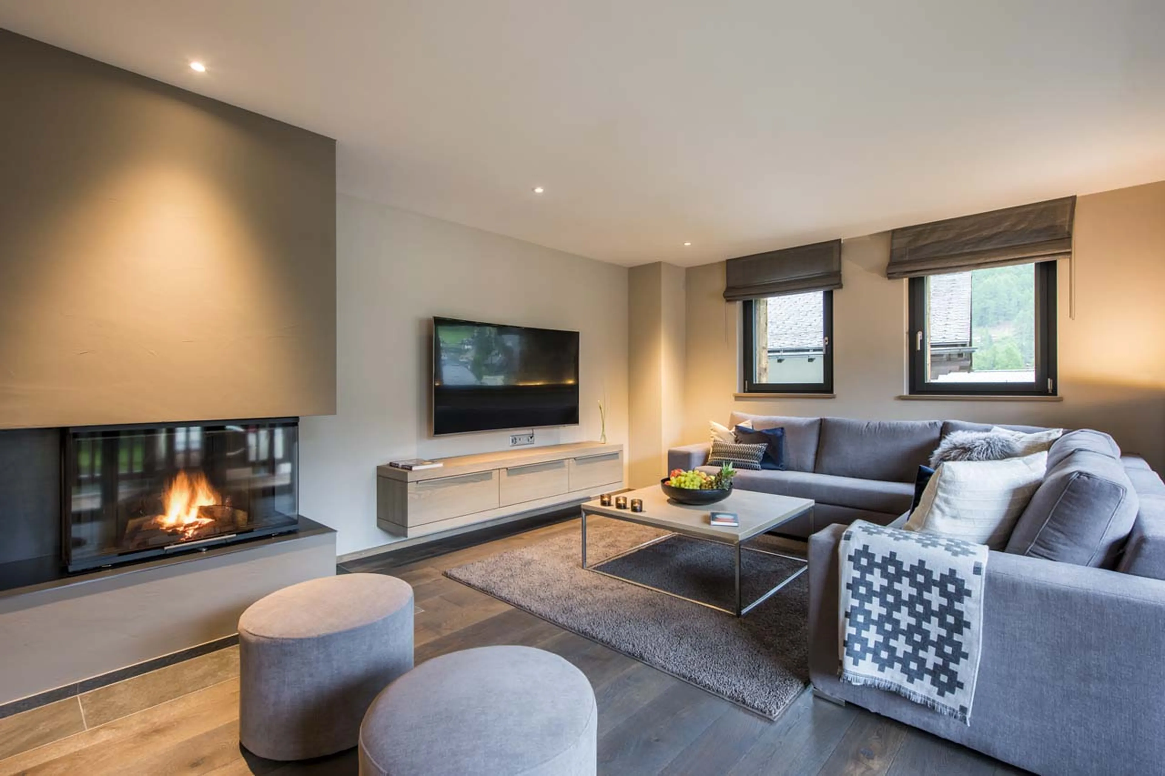 Fireplace and TV in living area of Christiania Apartment 7 in Zermatt