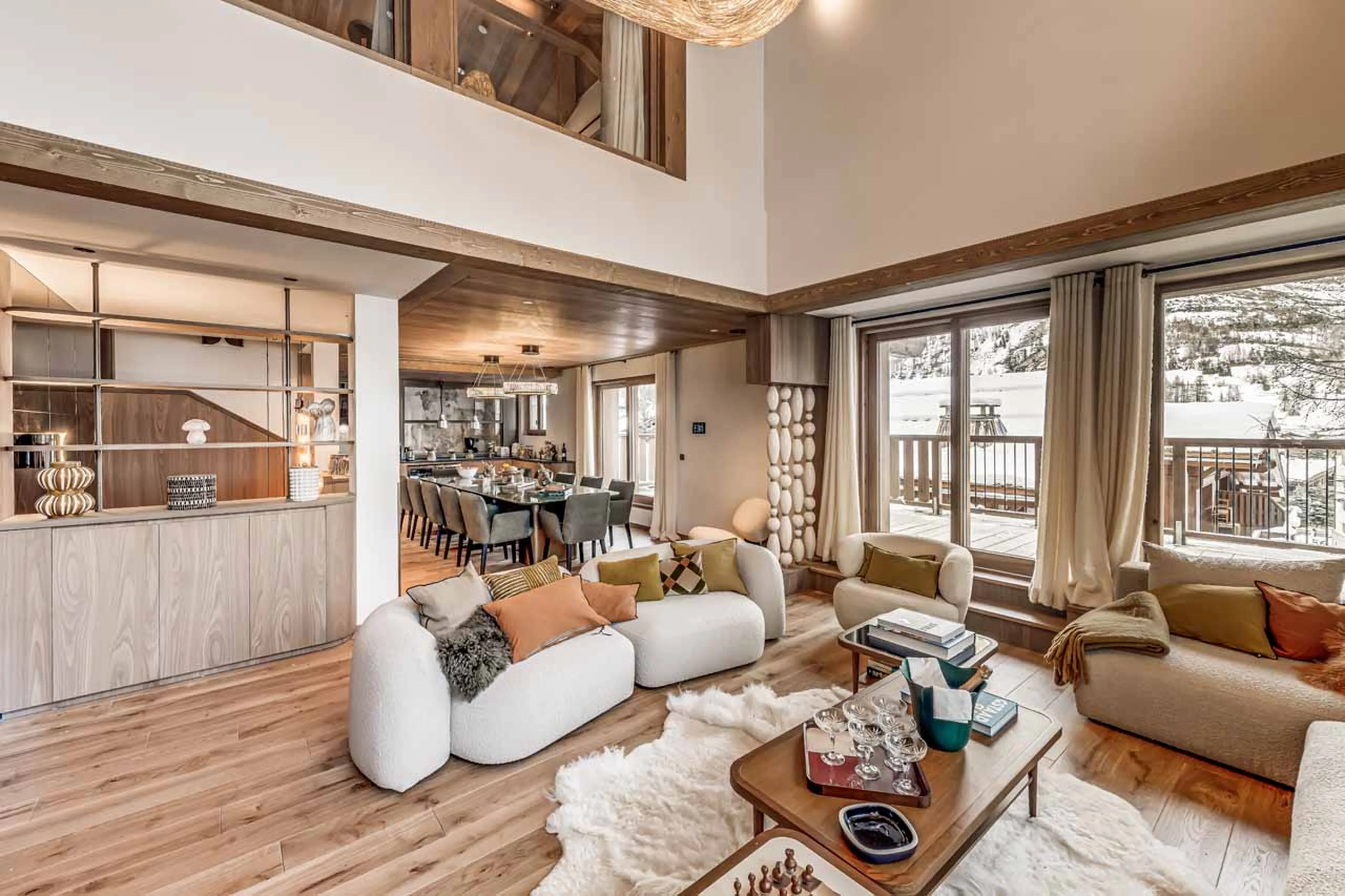 Sofas and coffee table in front of fireplace in Chalet des Legendes, Val d'Isere