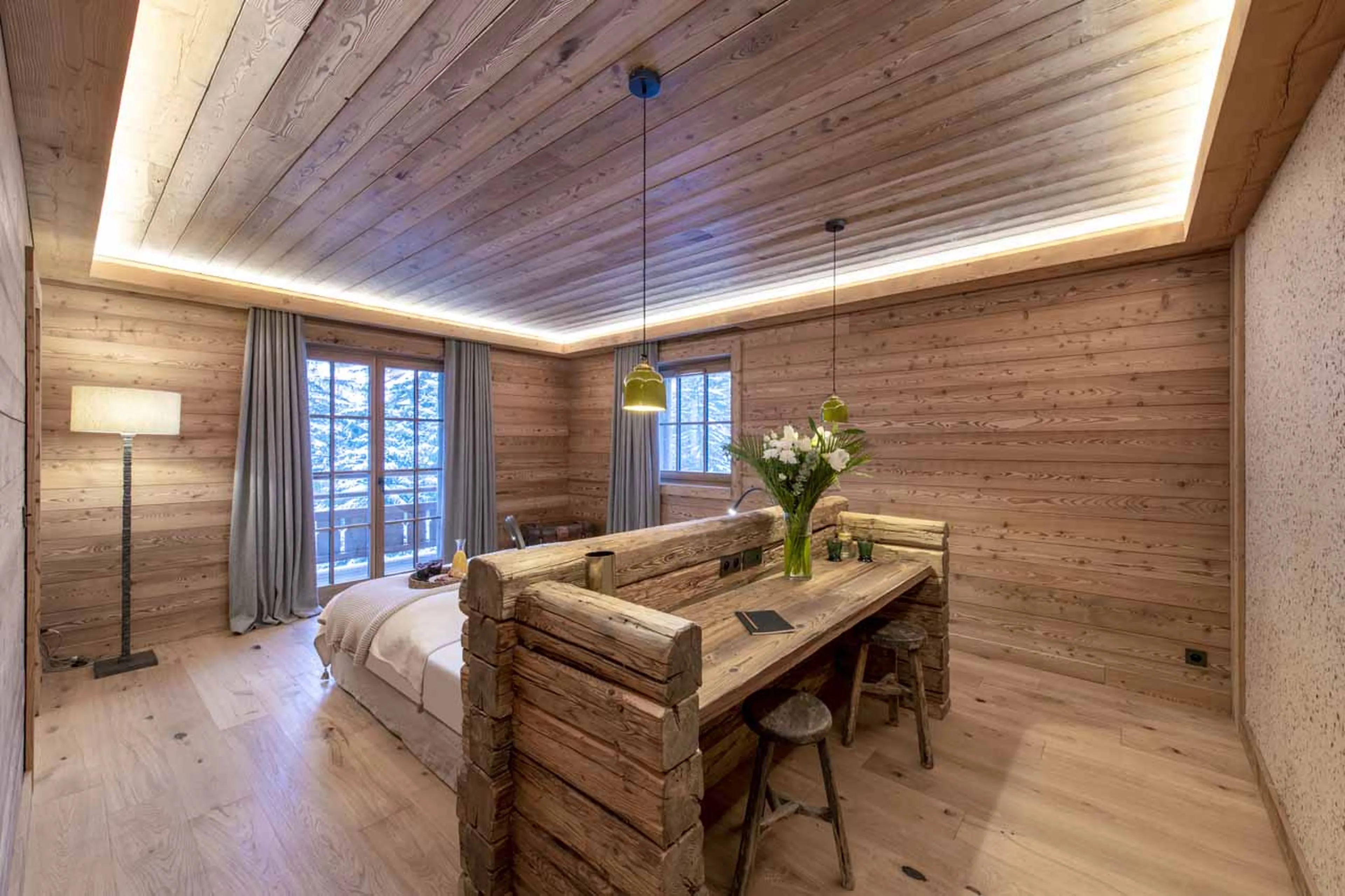 Bedroom opening onto balcony at Chalet Domaine de l'Orme in Meribel