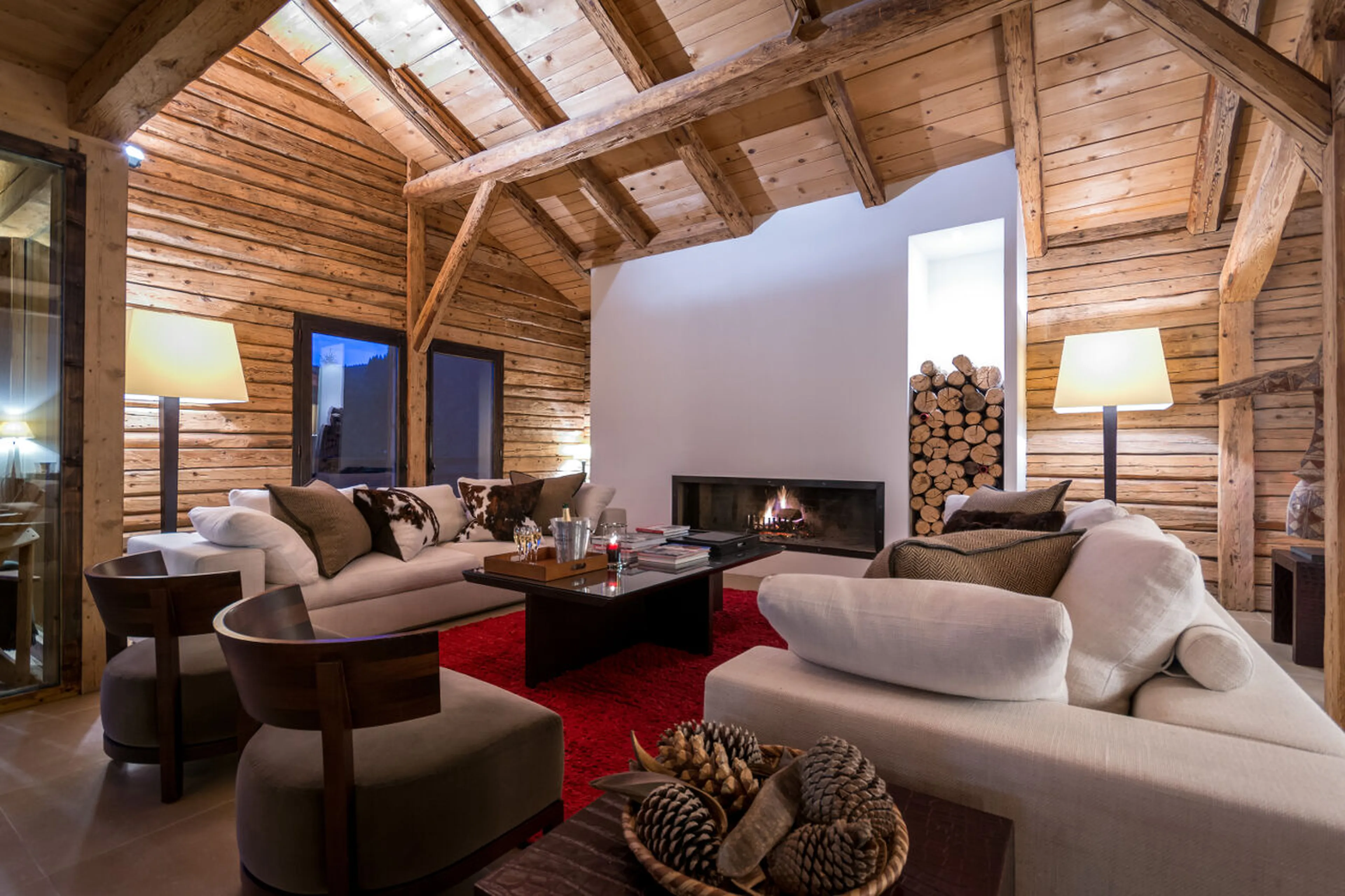 Elegant living area with open log fire in Ferme de Moudon, Les Gets
