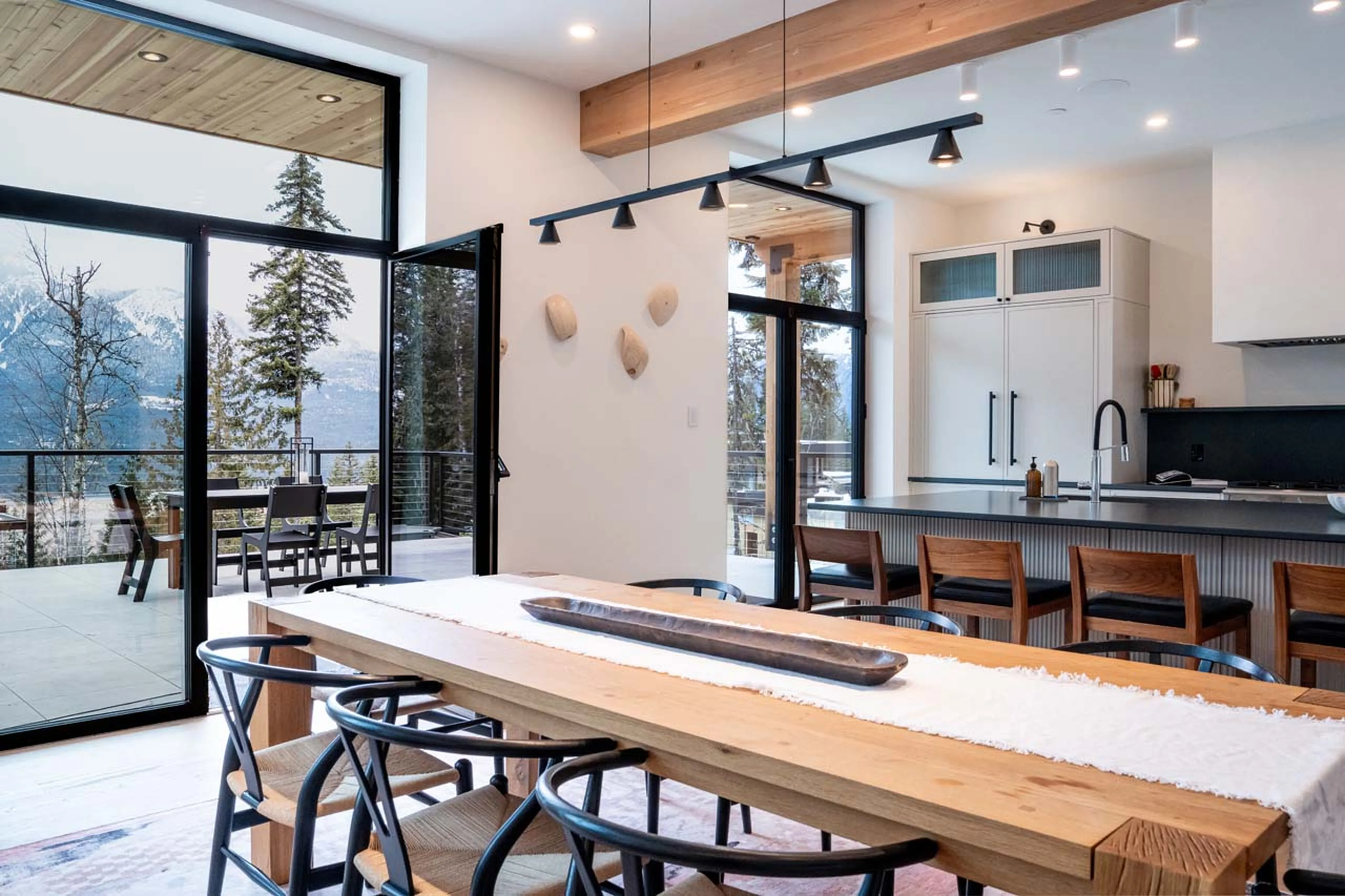 Dining table and access to terrace in Ghost Peak Chalet, Revelstoke