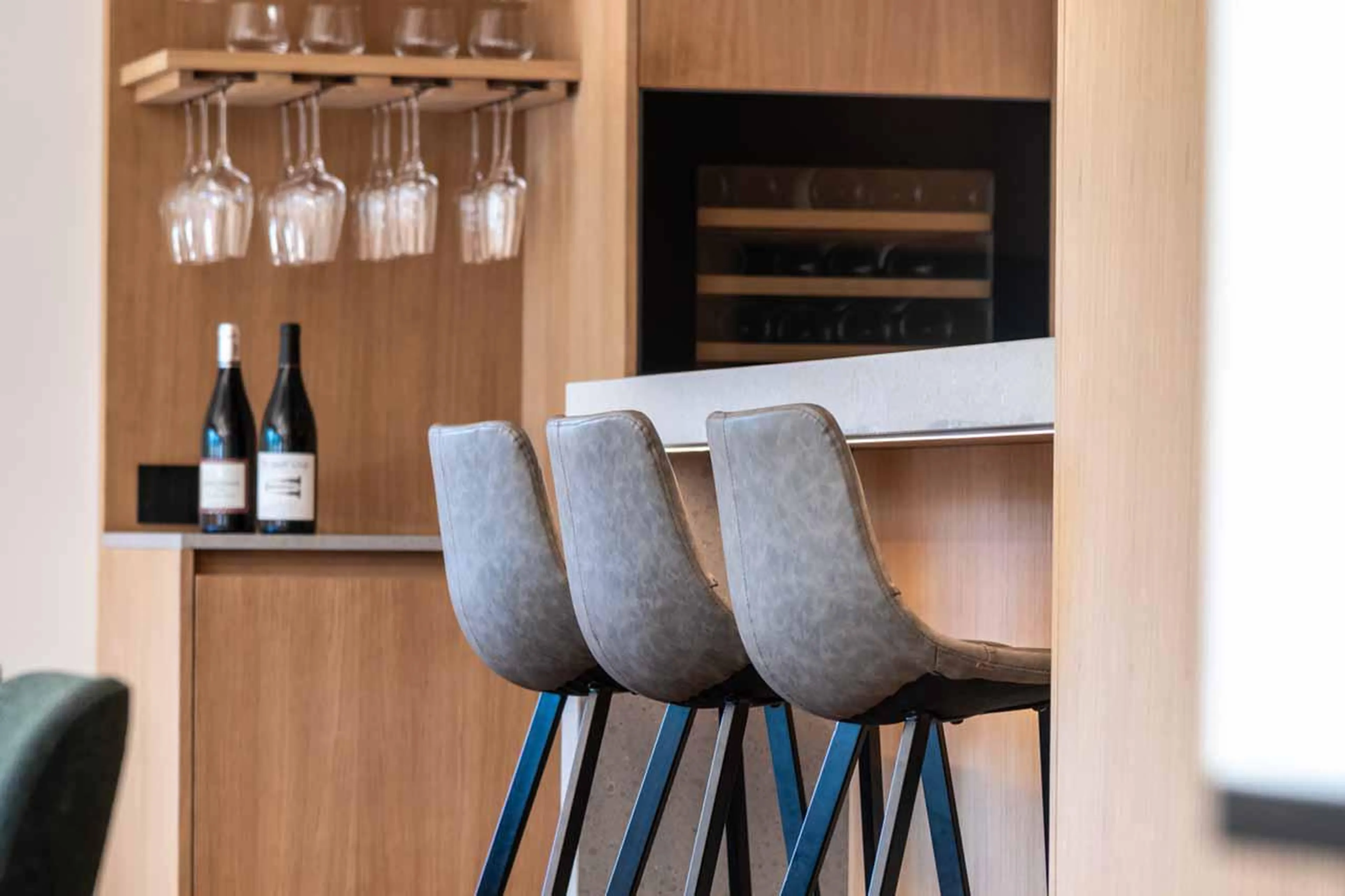 Breakfast bar with stools overlooking kitchen at Granite Mountain Lodge in Chamonix