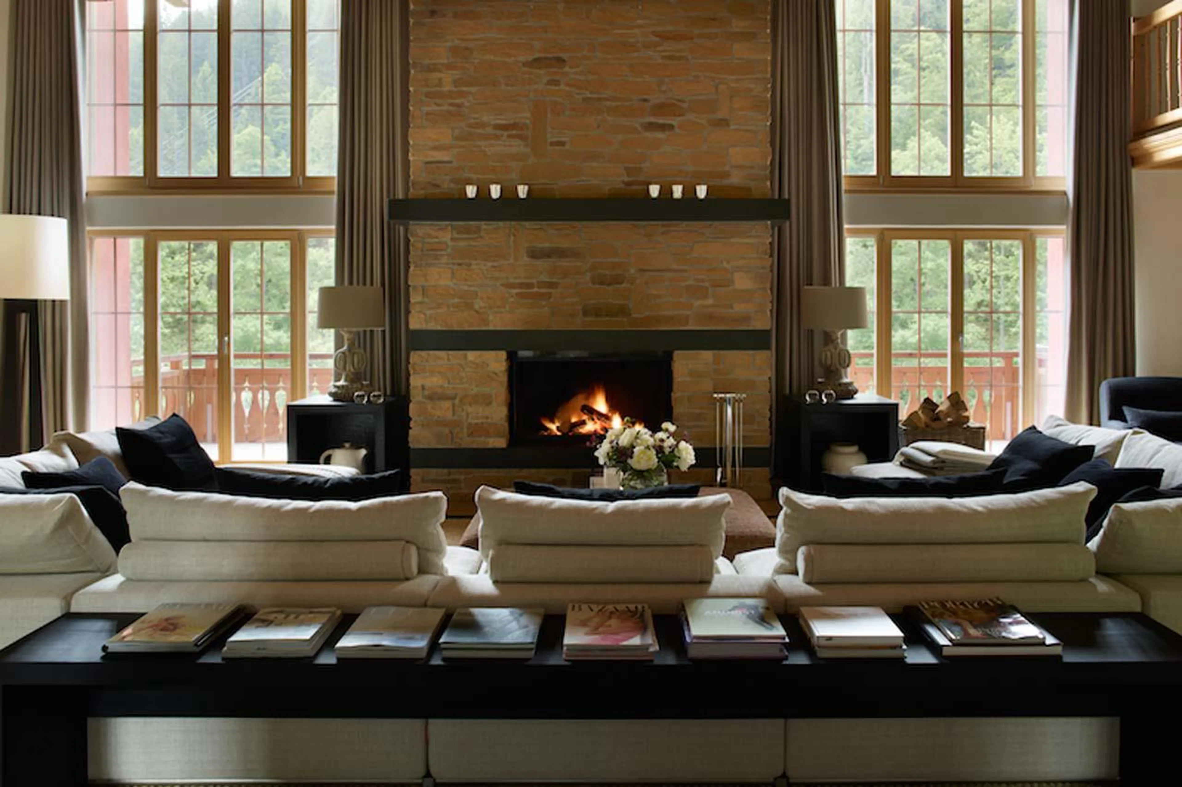 Drawing room with central fireplace in Haus Alpina in Klosters