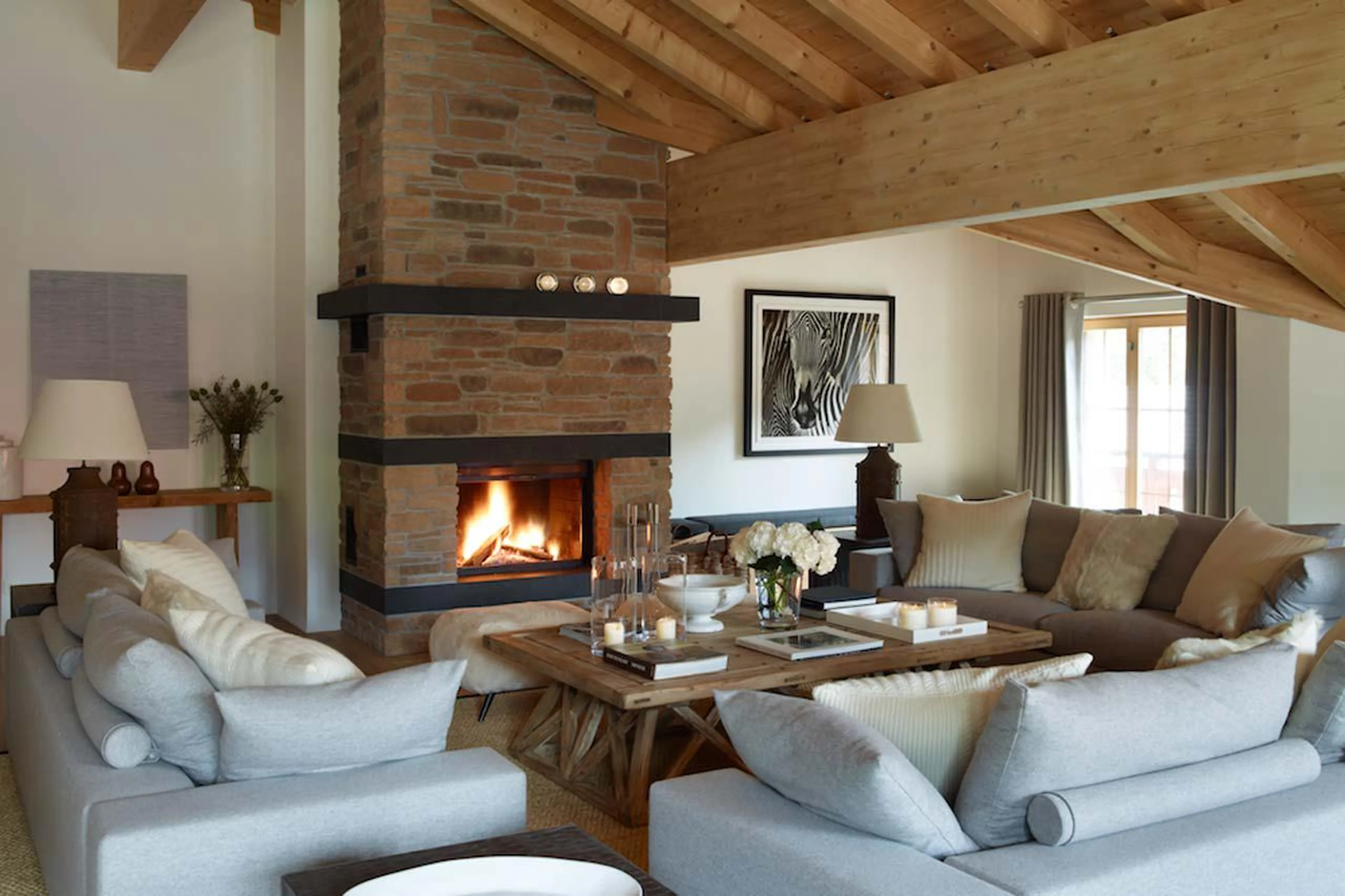 Log fireplace in formal lounge of Haus Alpina in Klosters