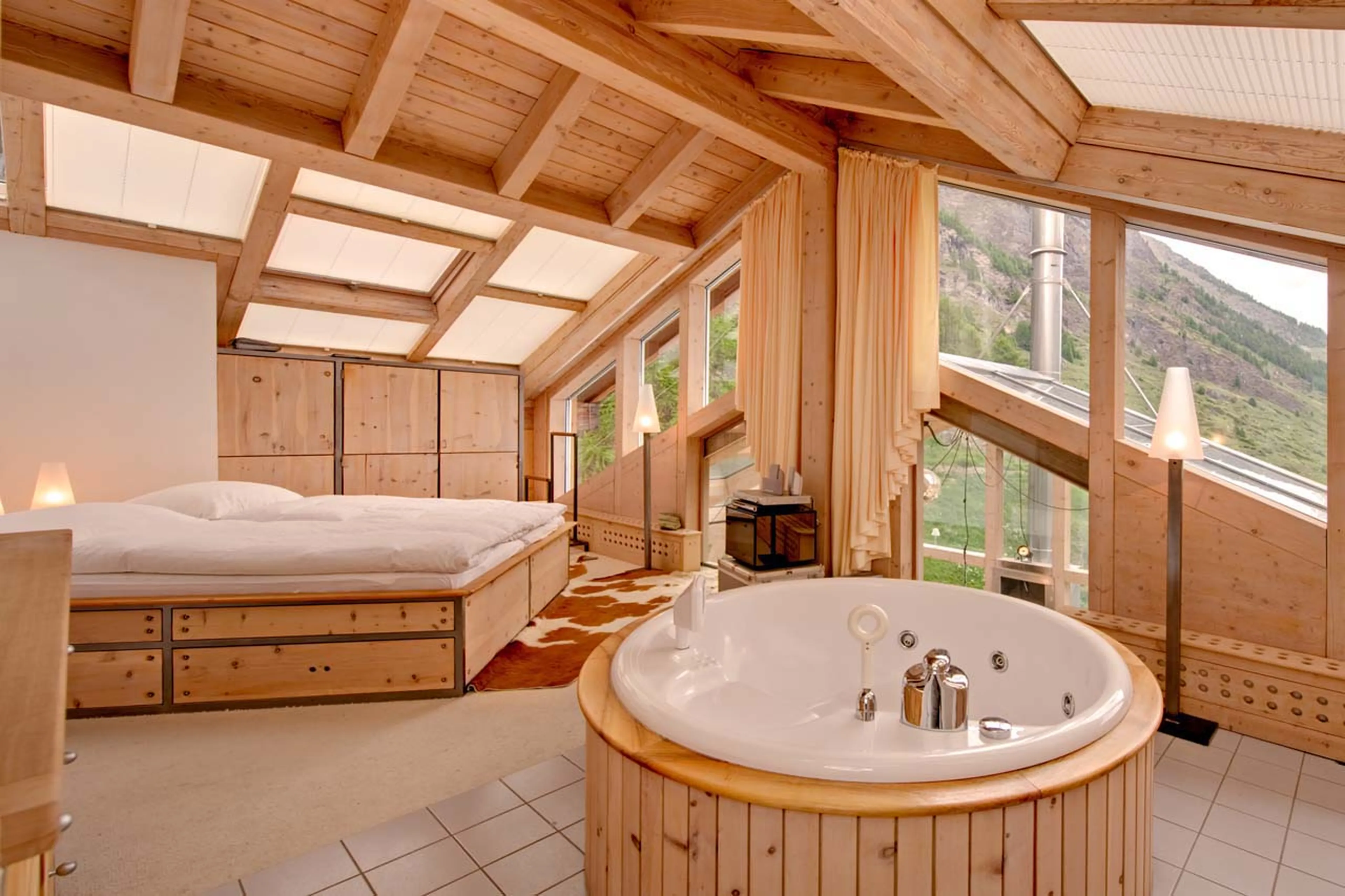 Sloping glass ceilings in bedroom one at Heinz Julen Penthouse in Zermatt