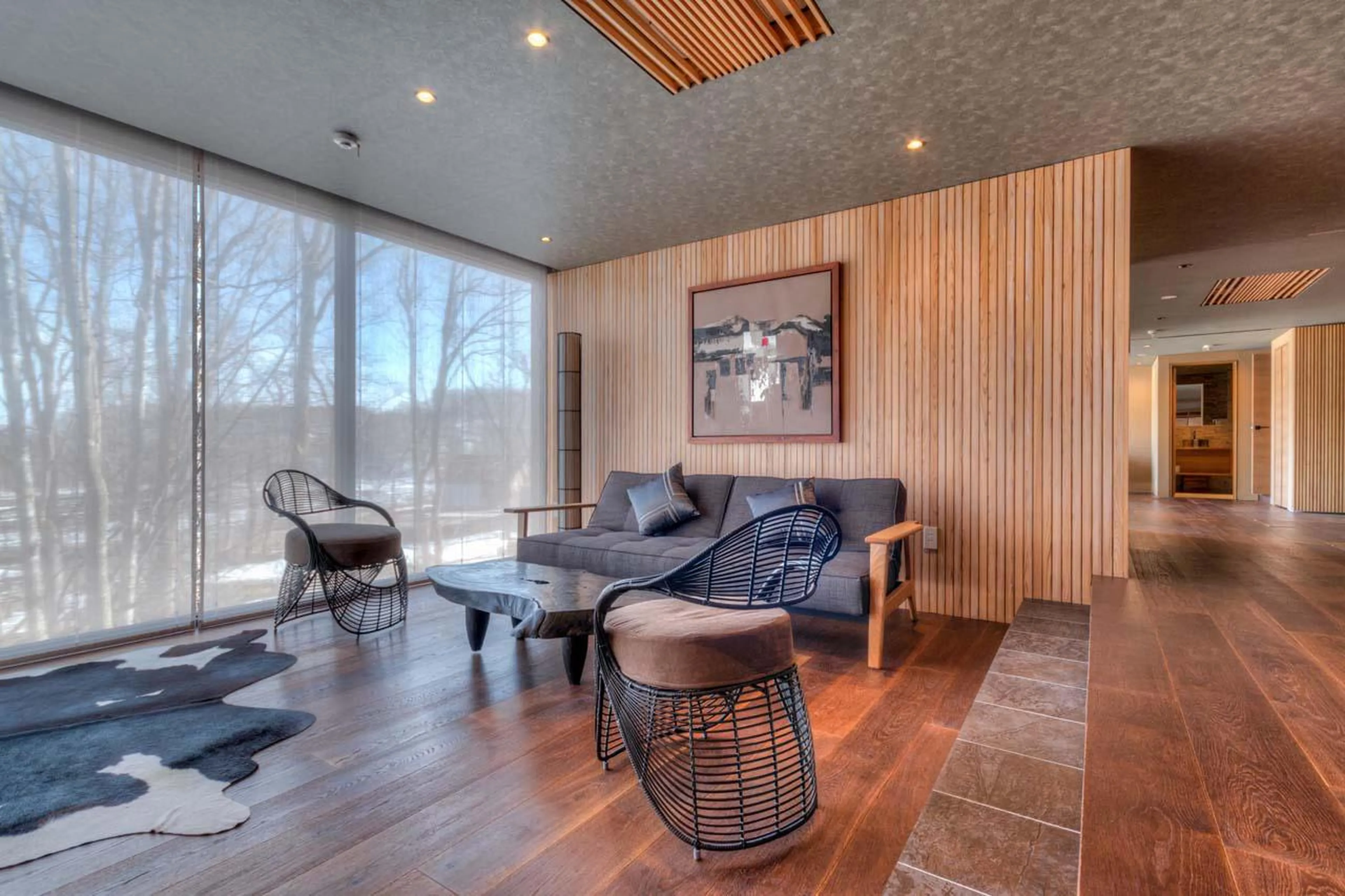 Expansive floor-to-ceiling windows next to sofa area at Hideaway on Escarpment in Niseko