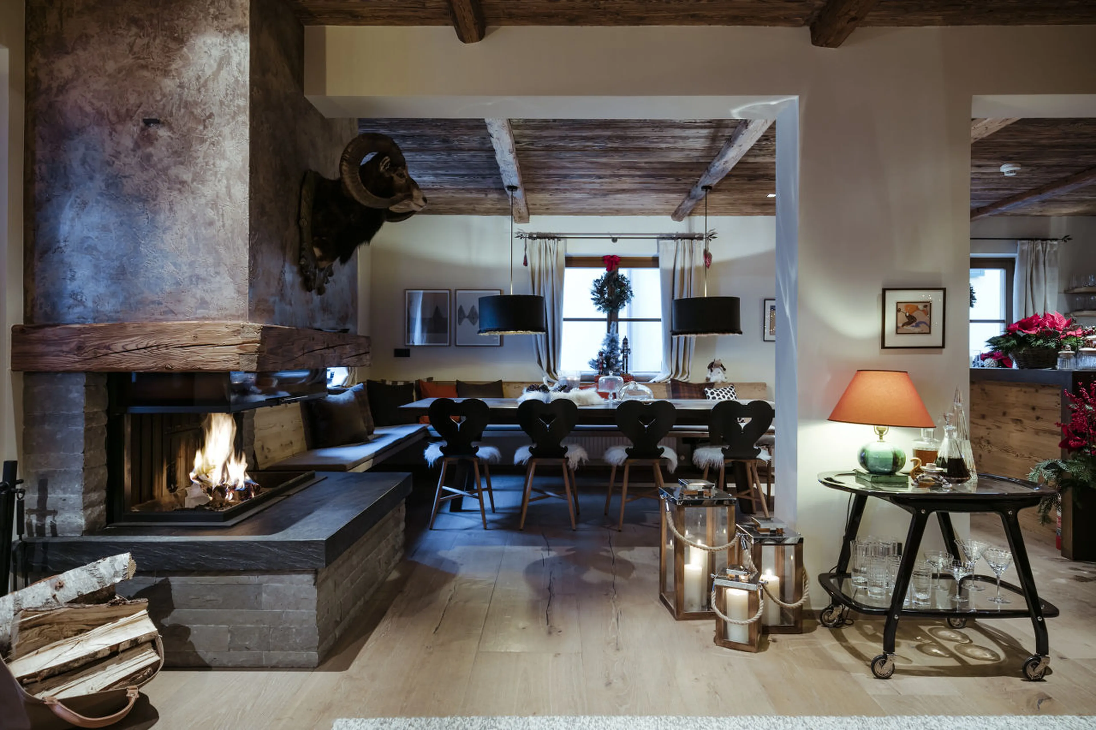 Central fireplace in open plan living area in House Hannes Schneider in Stuben, near Zürs
