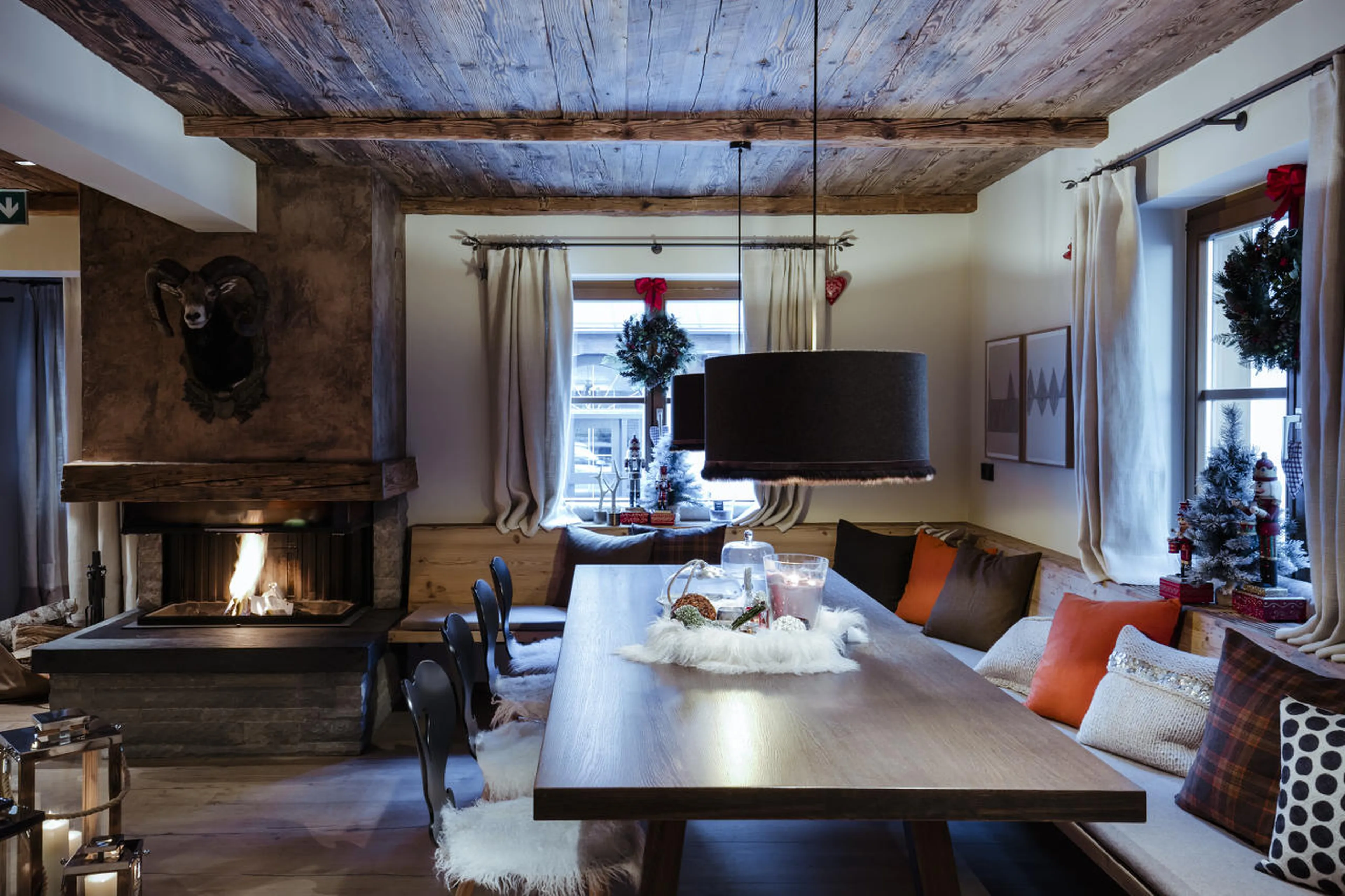 Dining table next to fireplace in House Hannes Schneider in Stuben, near Zürs