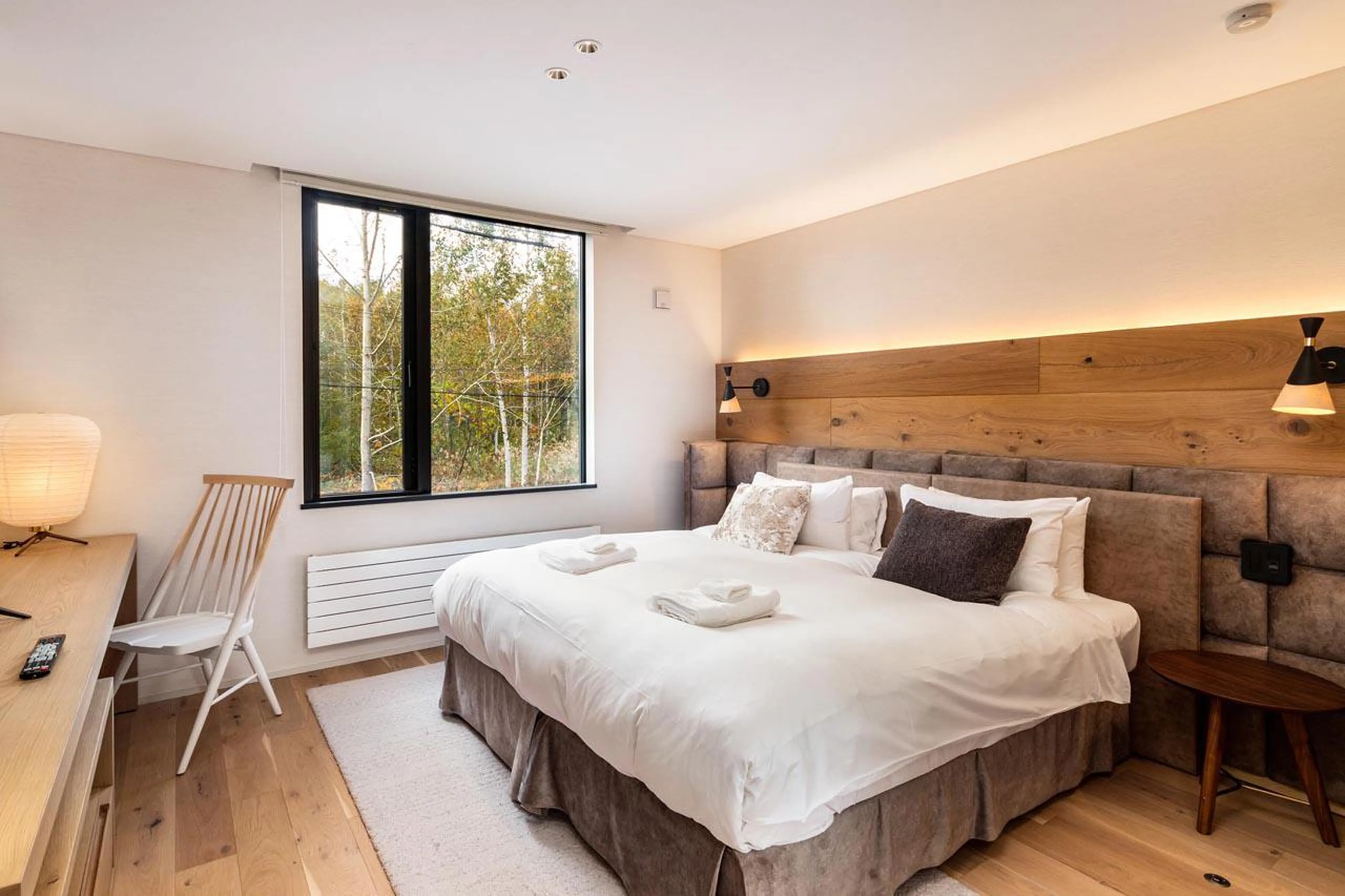 Master double bedroom with desk, TV and en-suite bathroom at Koa Townhouse in Niseko