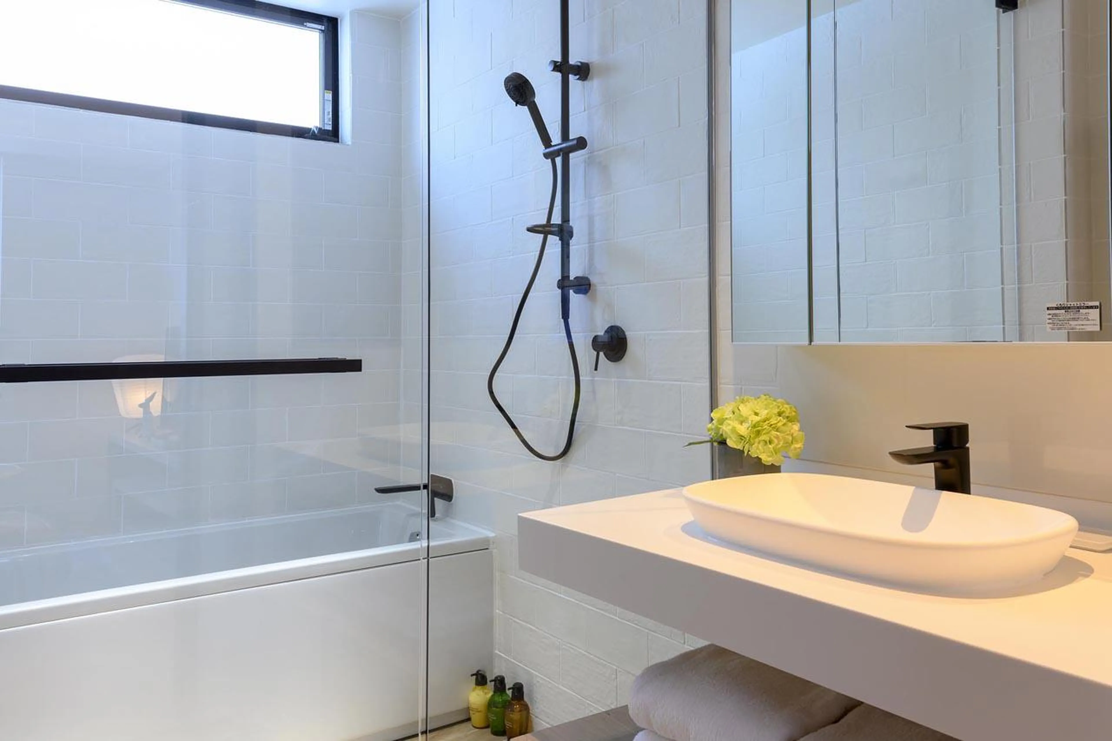 Bathroom with bath and separate shower at Koa Villa in Niseko