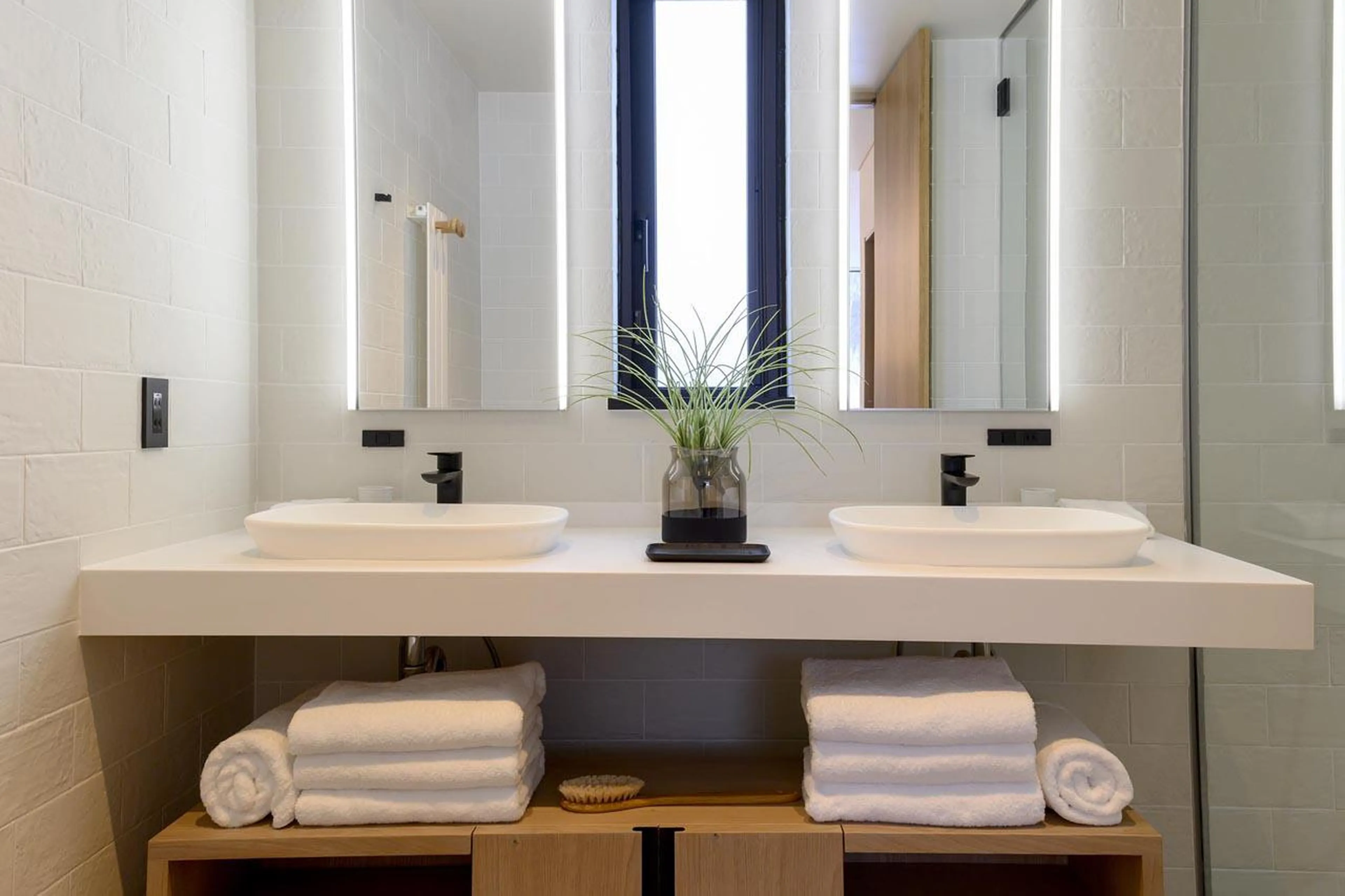 En-suite bathroom with bath and separate shower at Koa Villa in Niseko
