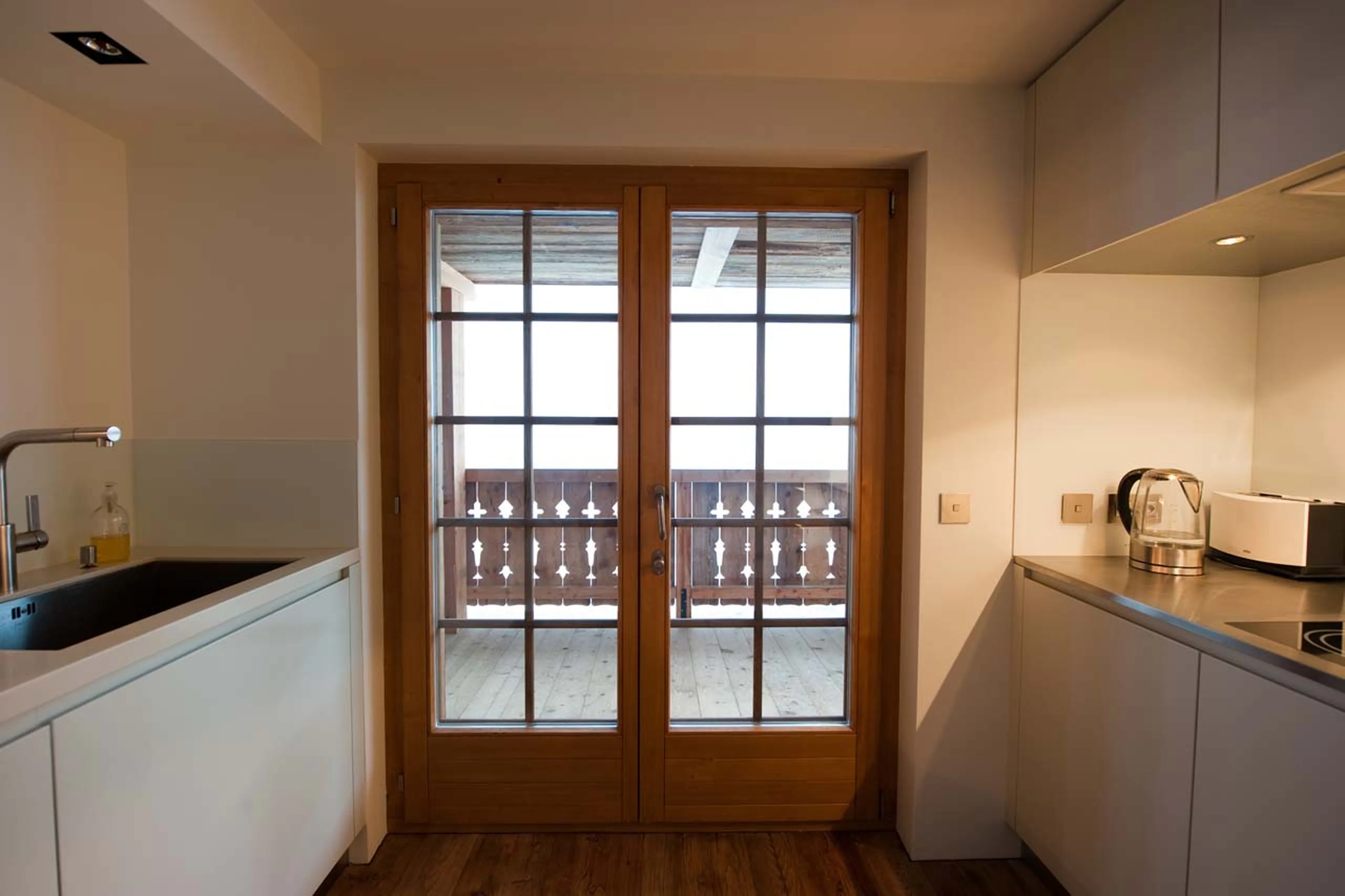 Doors to balcony from kitchen in La Vallée Blanche in Verbier