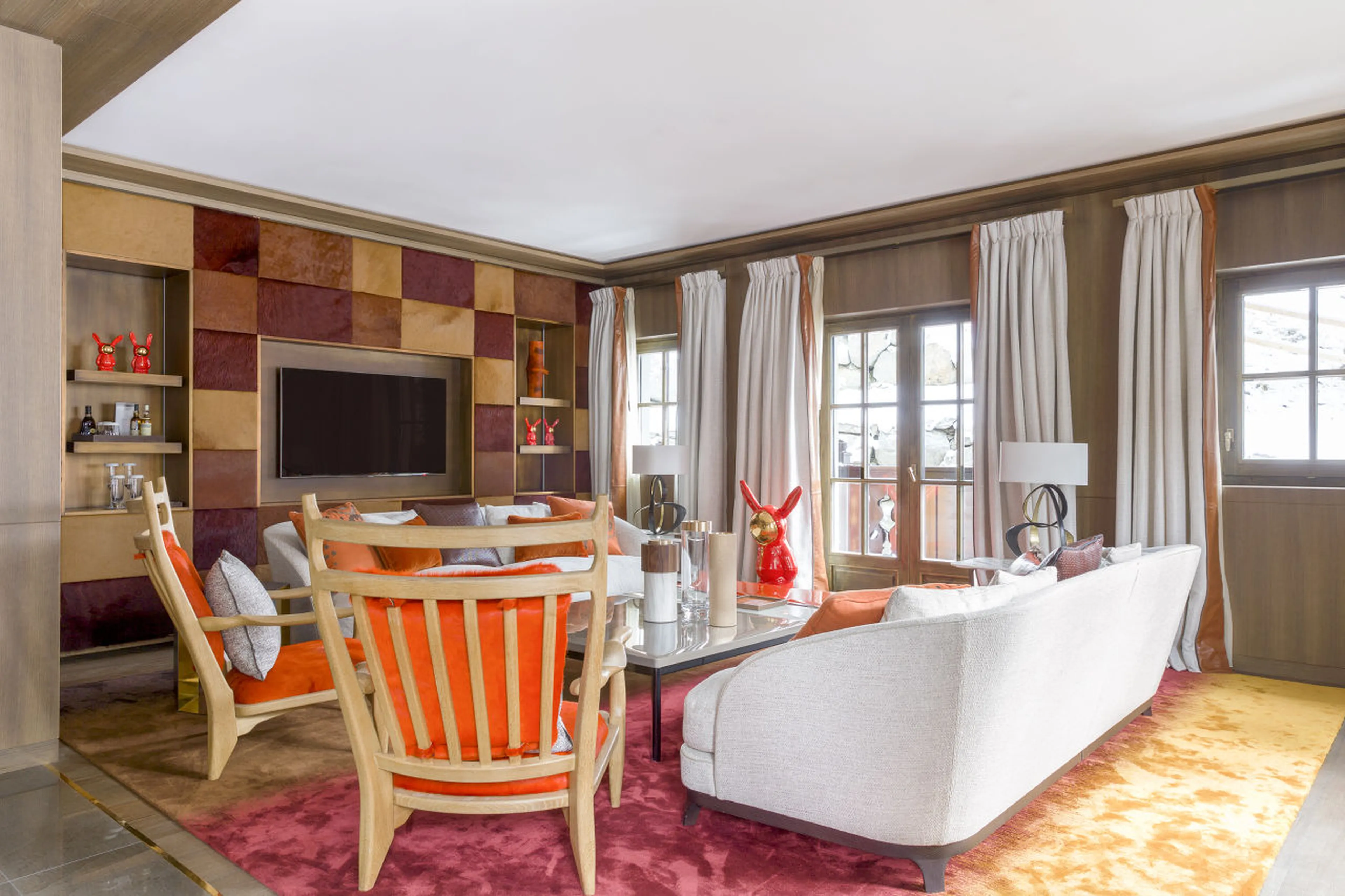 Lounge with balcony access in Le Chalet Cheval Blanc in Courchevel 1850