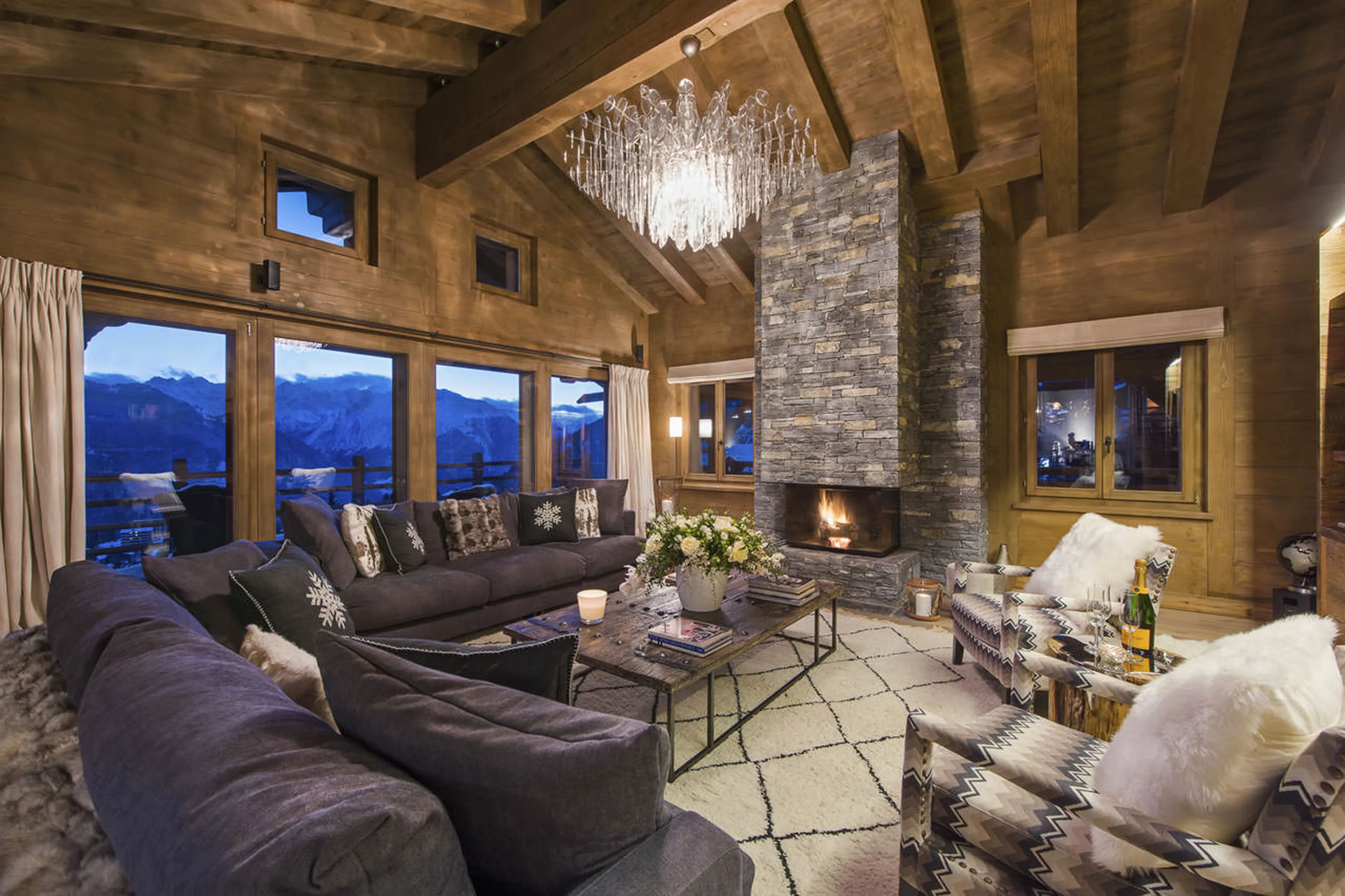French windows opening onto terrace from living room of Le Daray Penthouse in Verbier