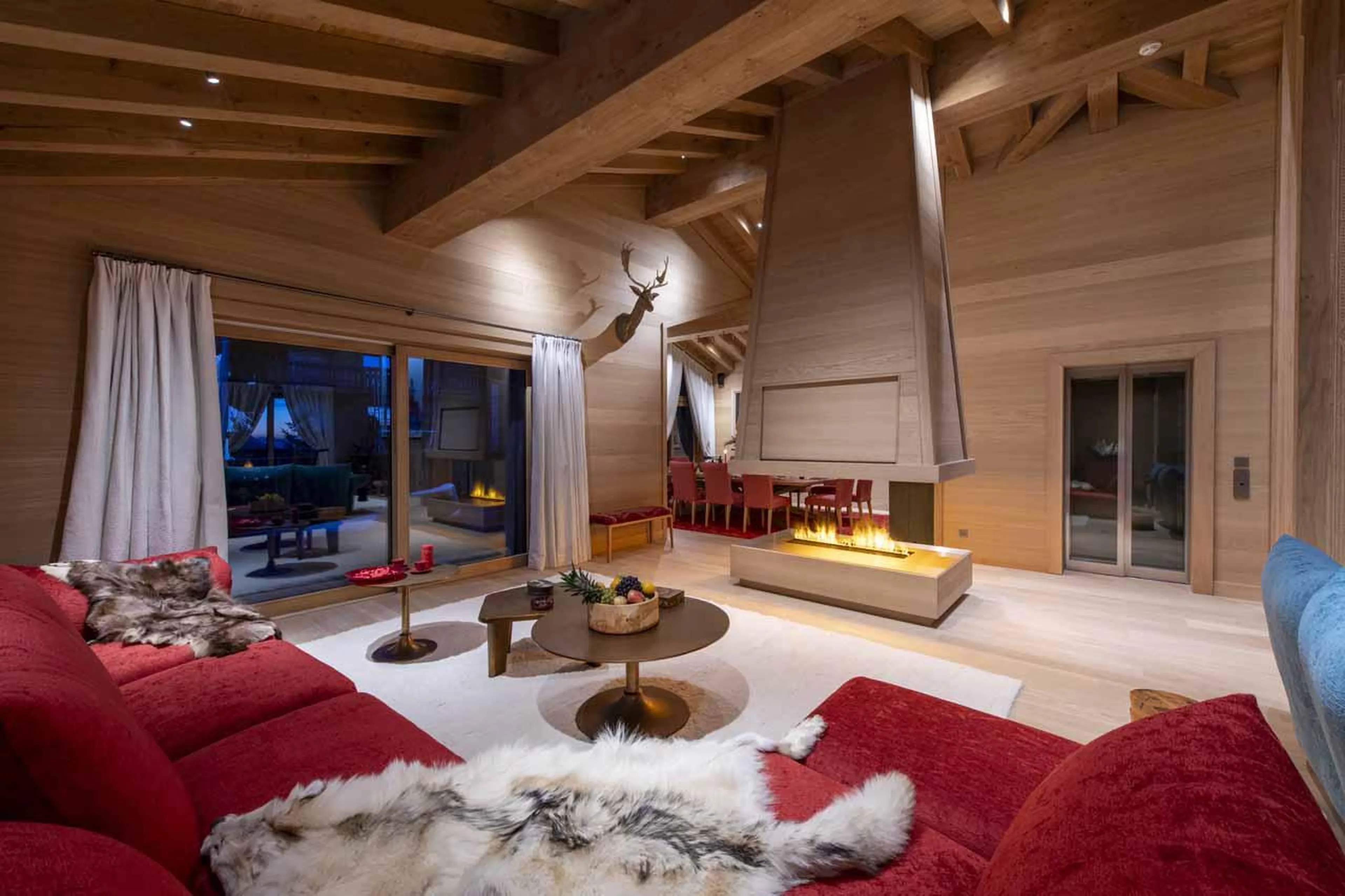 Open-plan living and dining area with corner sofa and fireplace in Lord of Snow, Courchevel 1850