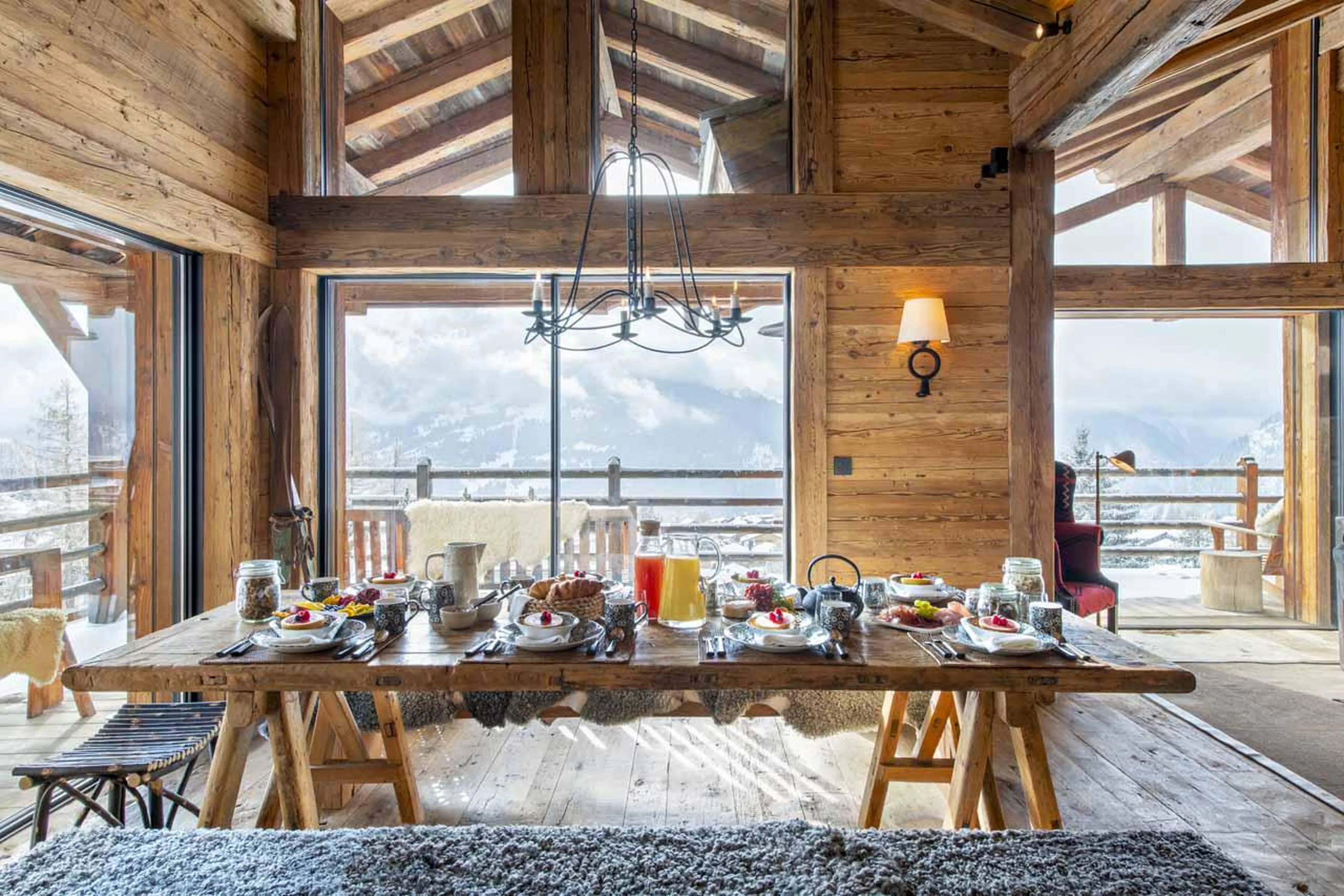 Dining table overlooking panoramic mountain views at Marmotte Penthouse in Verbier