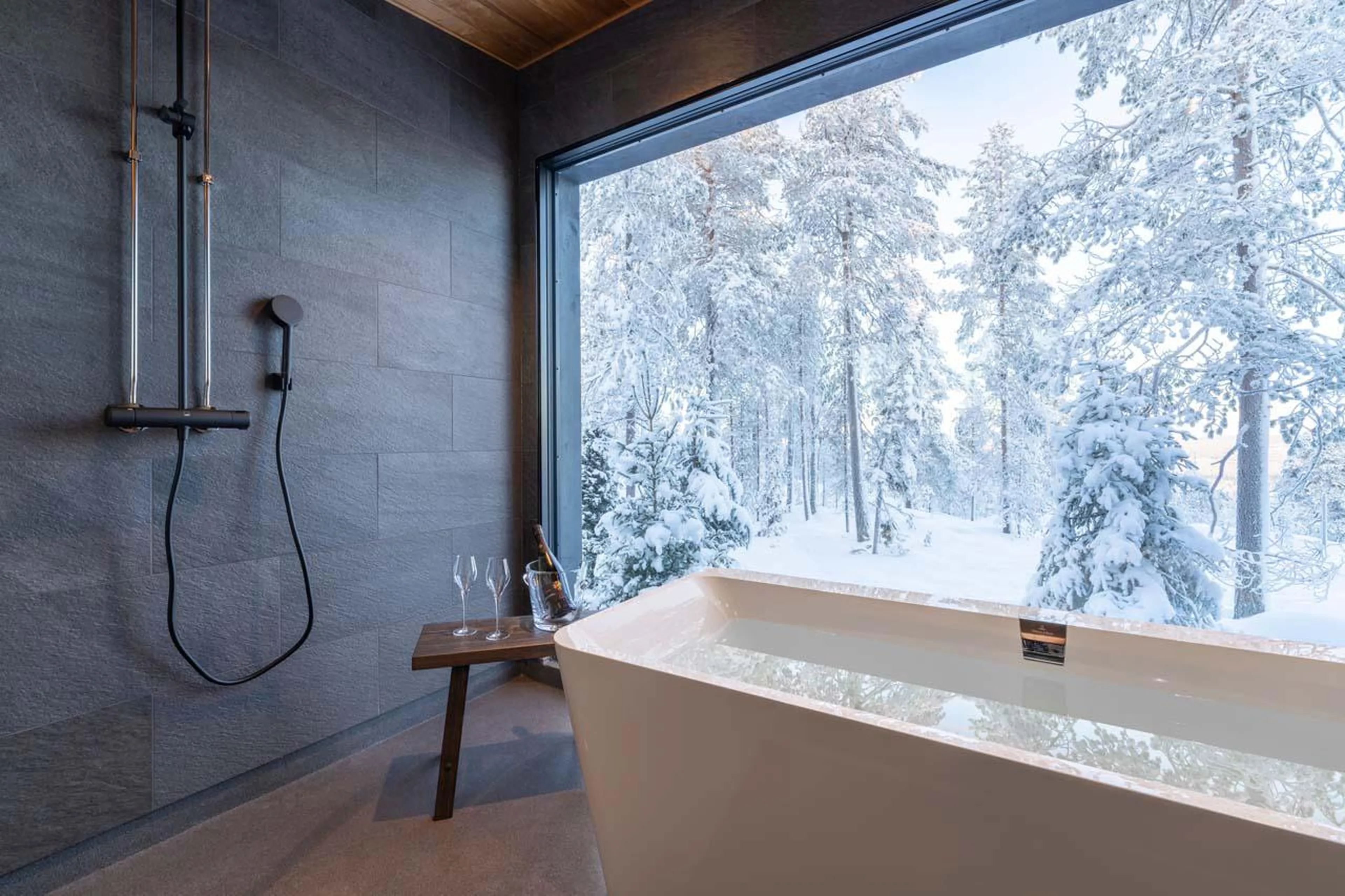 Bath overlooking the snowy scenery at Octola Glass Igloo in Finland