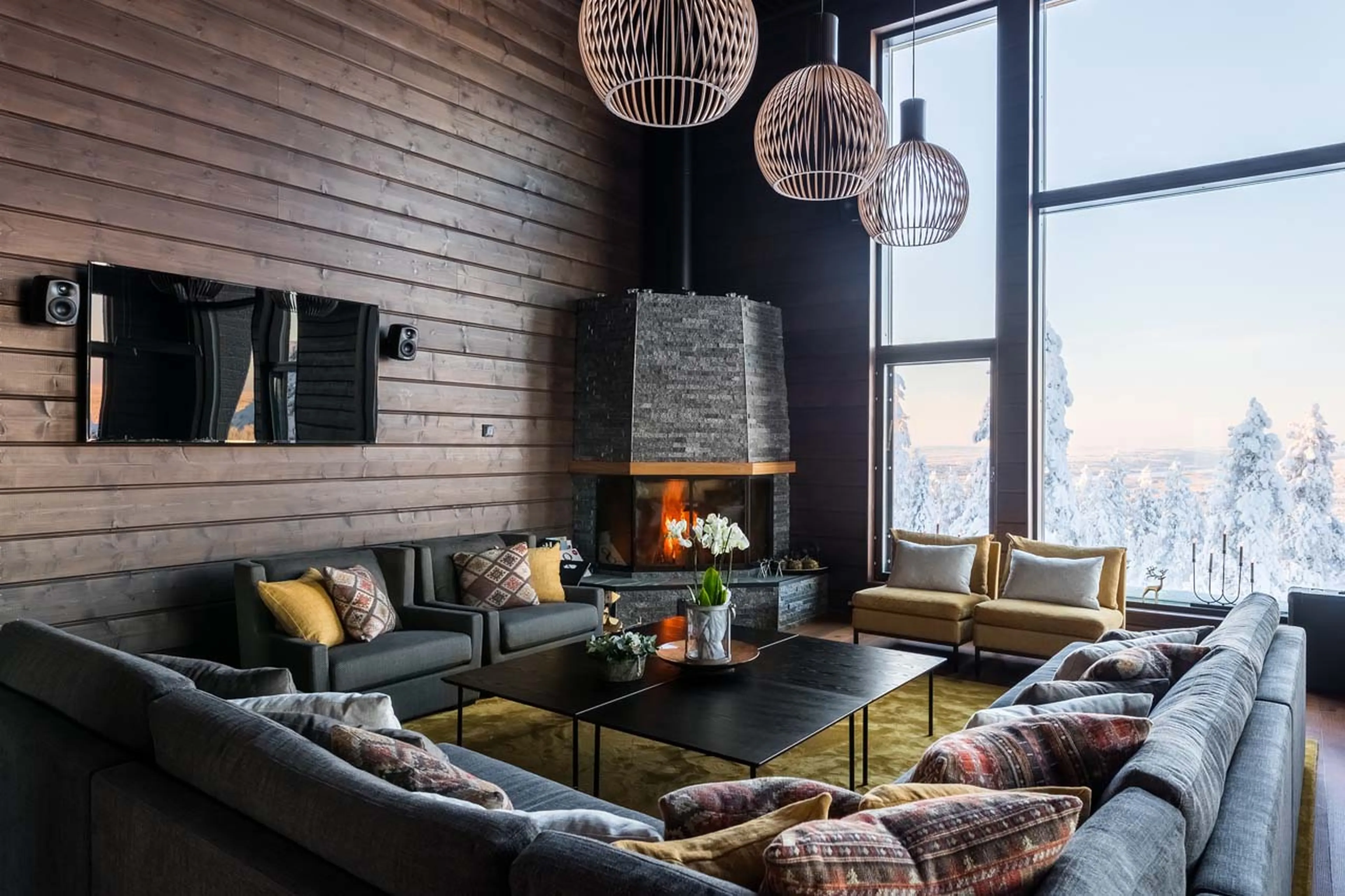 Fireplace in living room of Octola Private Wilderness in Finland