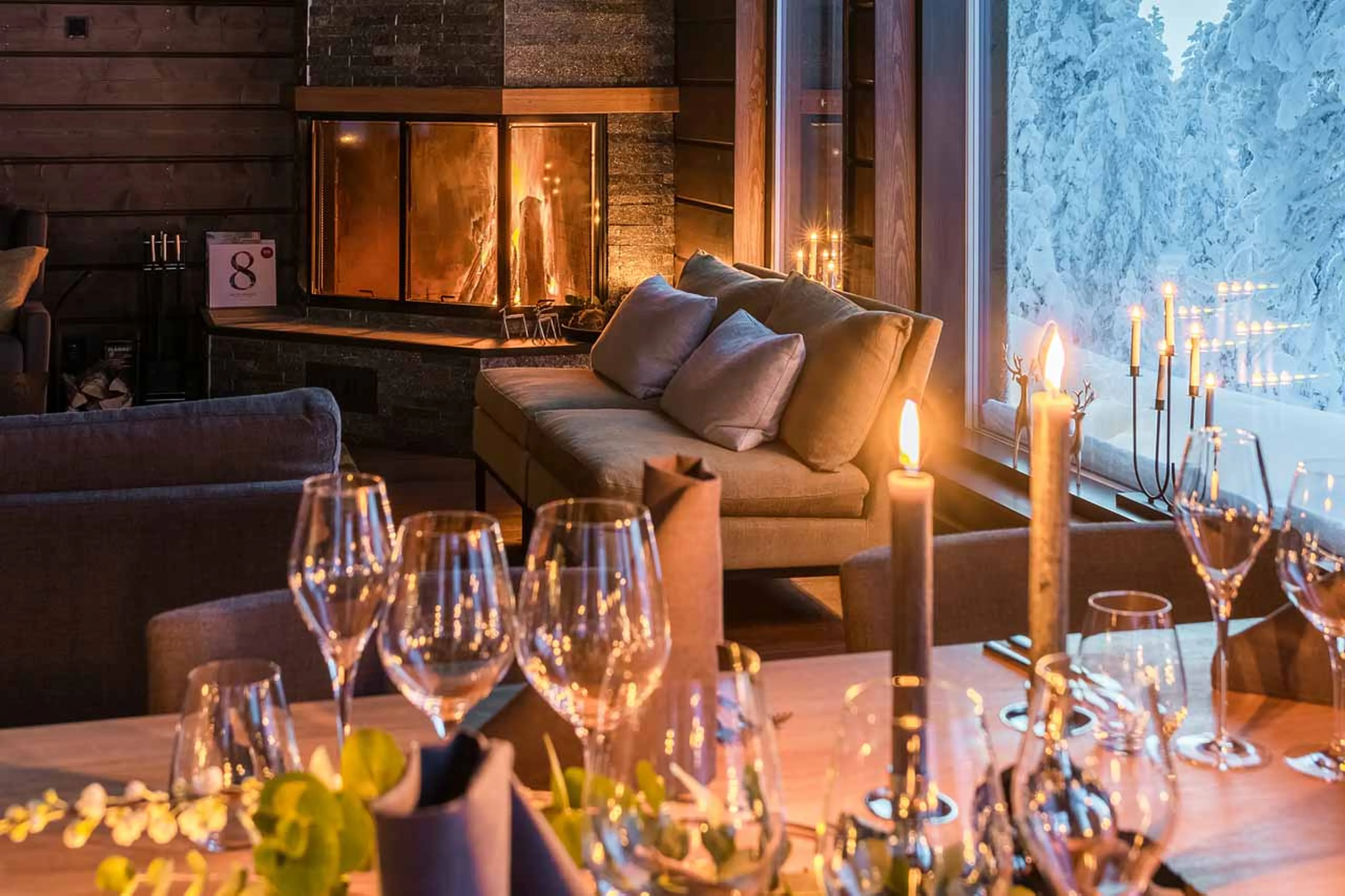 Candlelit dining table at Octola Private Wilderness in Finland