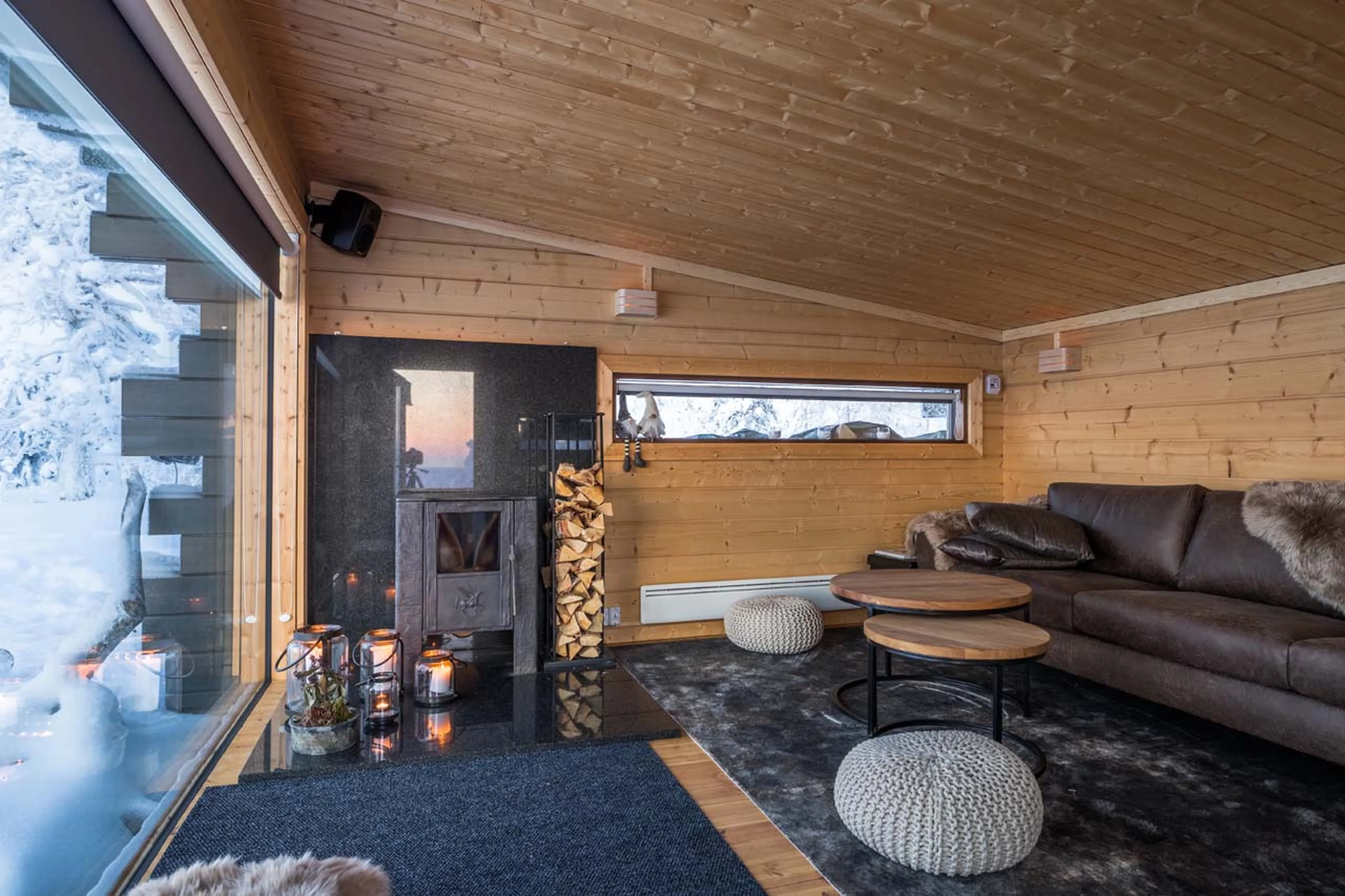 Sofa in lounge area of Octola Private Wilderness in Finland