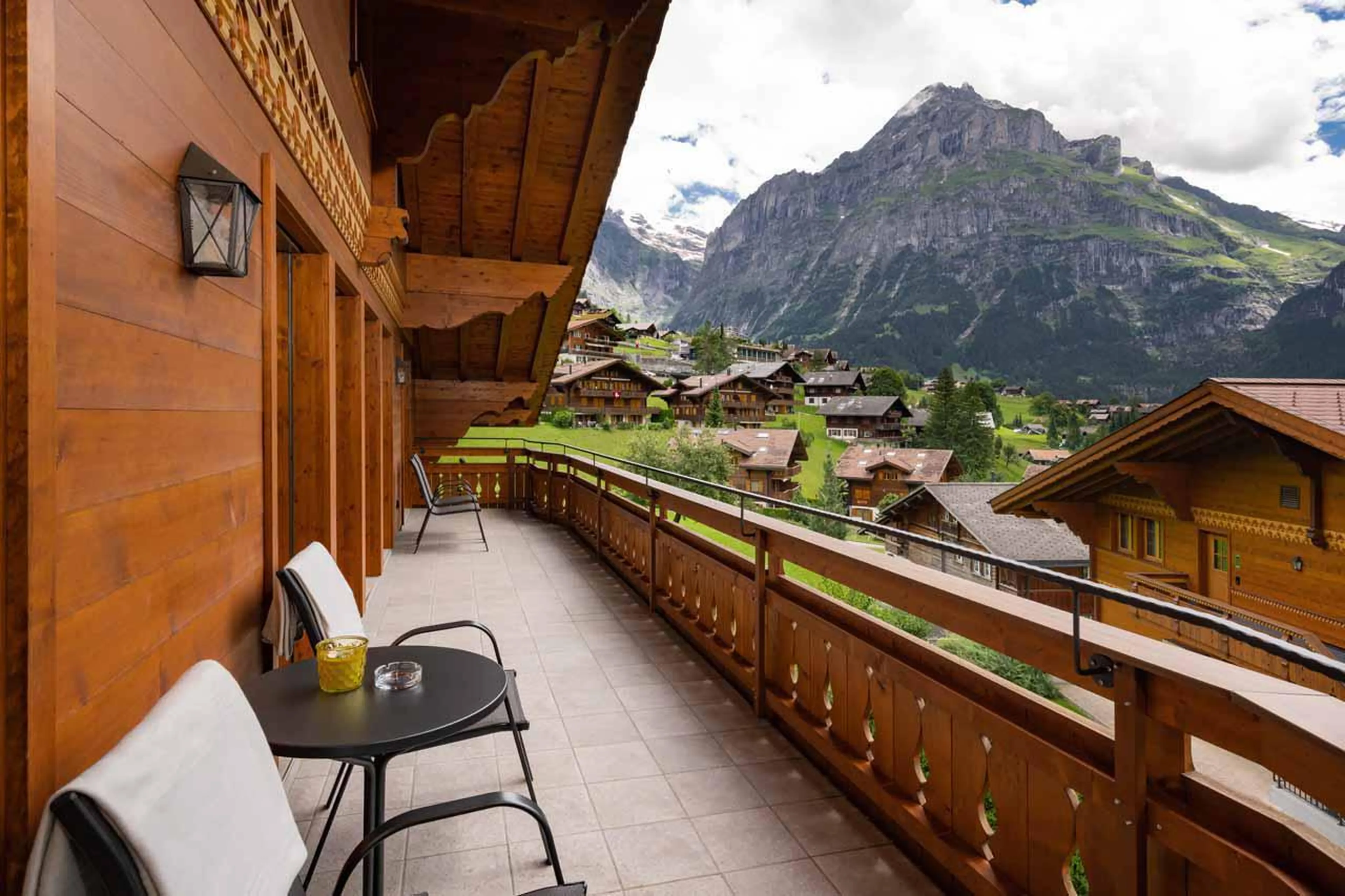 Balcony with seating and beautiful mountain views at Chalet Alia in Grindelwald