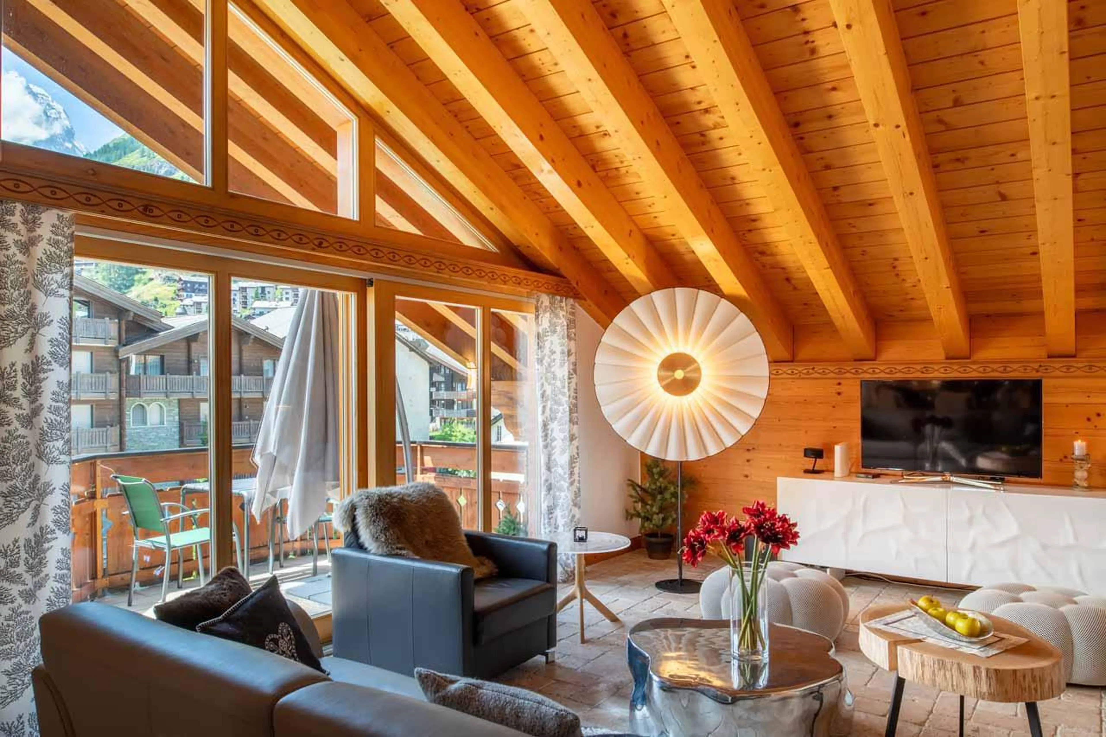 Living area opening onto balcony at Penthouse Annyvonne in Zermatt