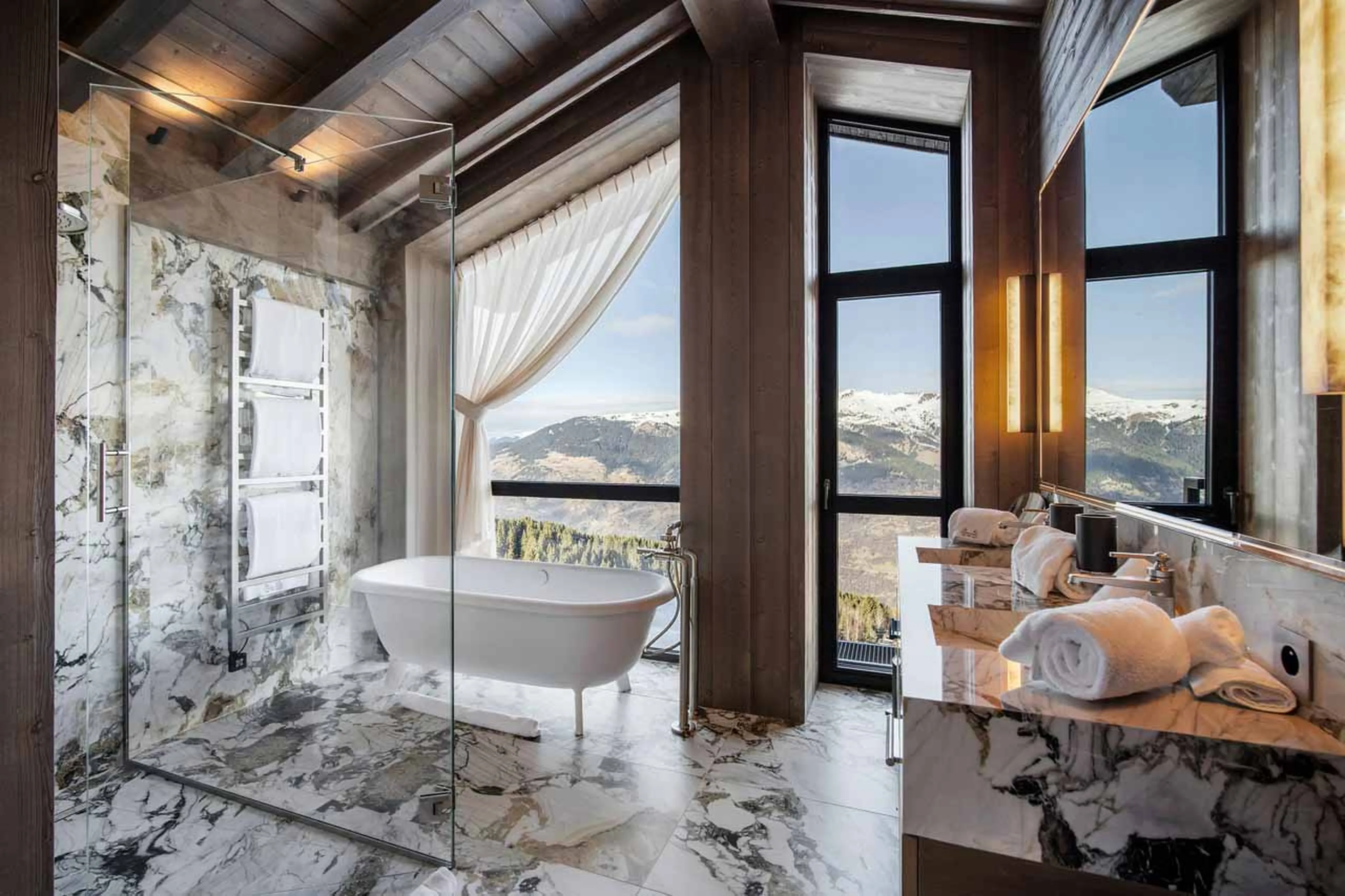 En-suite bathroom with expansive vaulted windows in Atmosphere Penthouse, Courchevel 1850