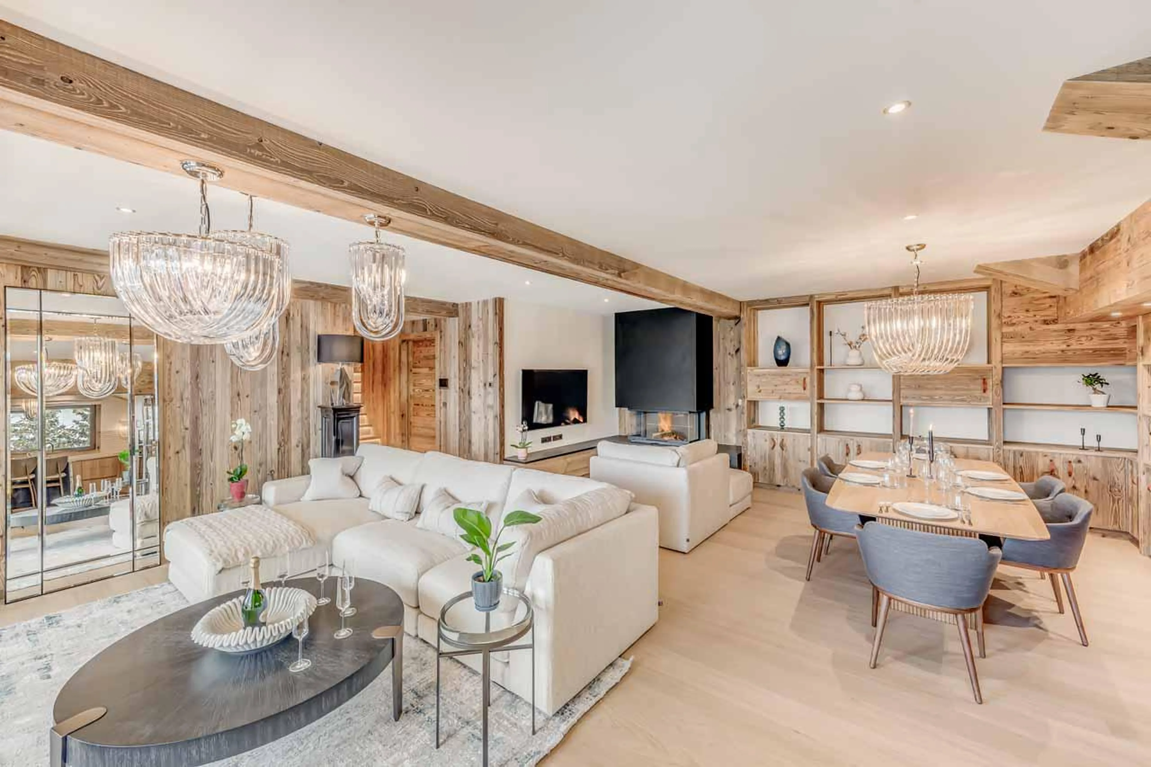 Sophisticated open-plan living space with TV and fireplace at Penthouse B in Courchevel 1850
