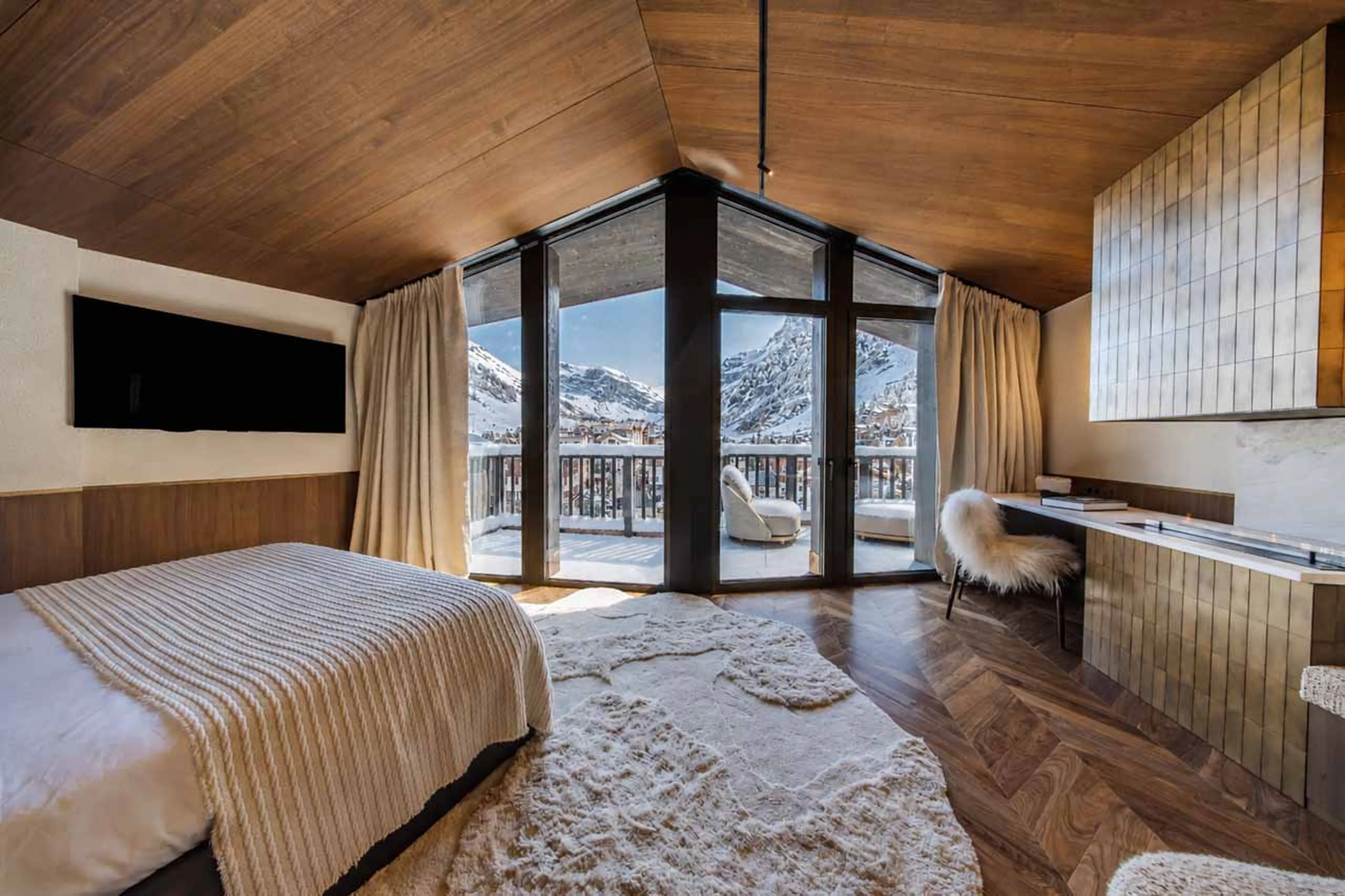 TV and access to balcony from master bedroom at Penthouse Cristal in Val d'Isere