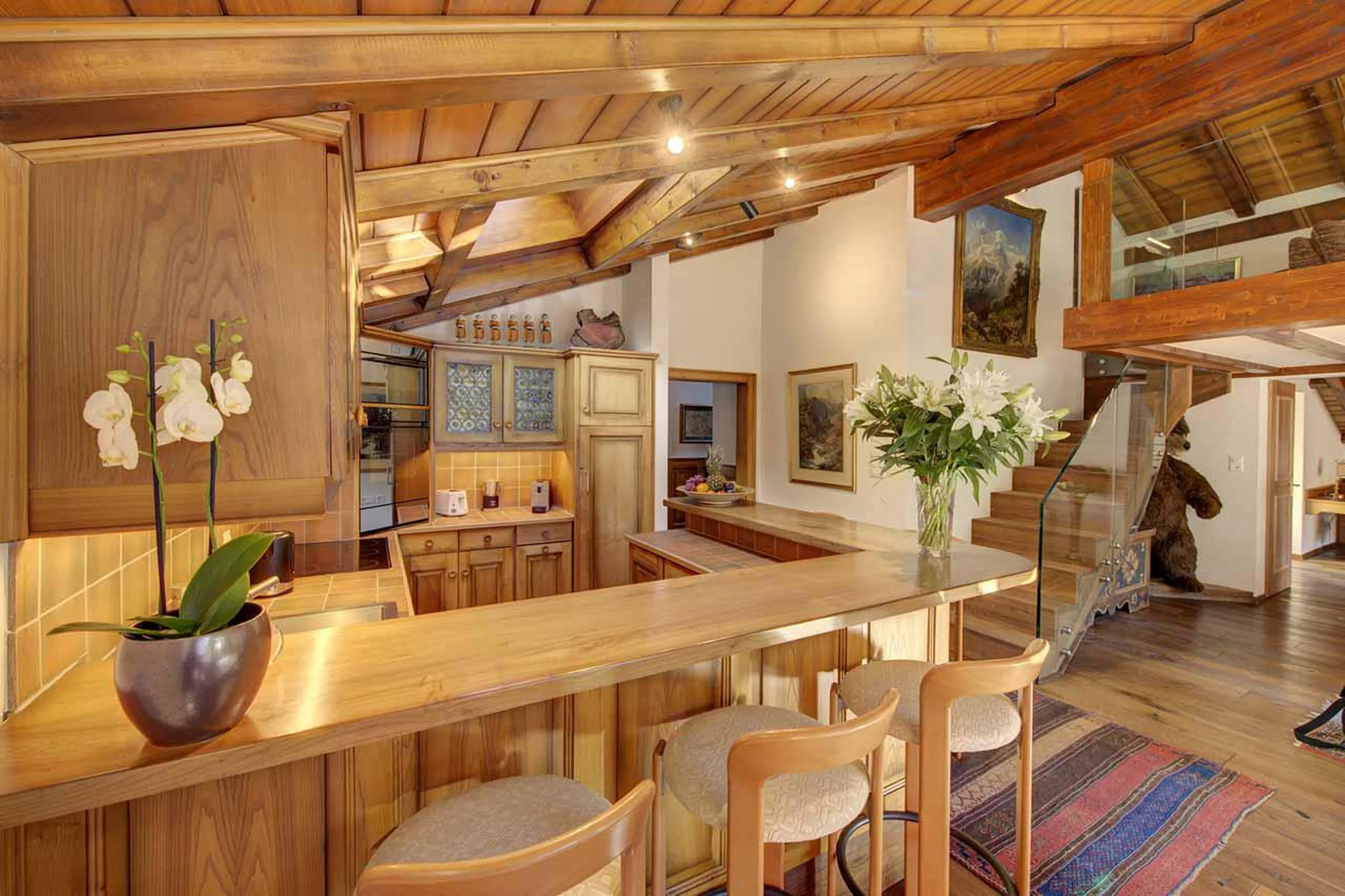 Kitchen bar area within open-plan living space at Penthouse Zen in Zermatt