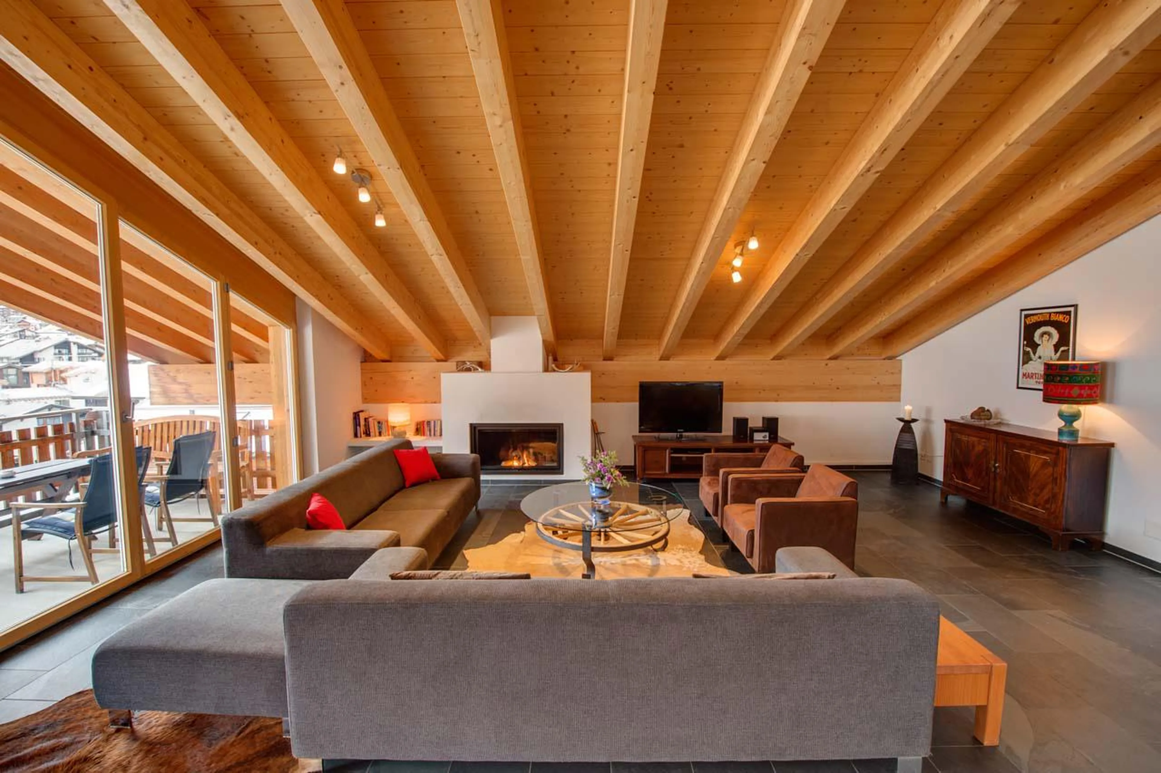 Living room with fireplace and seating area at Penthouse Zora in Zermatt
