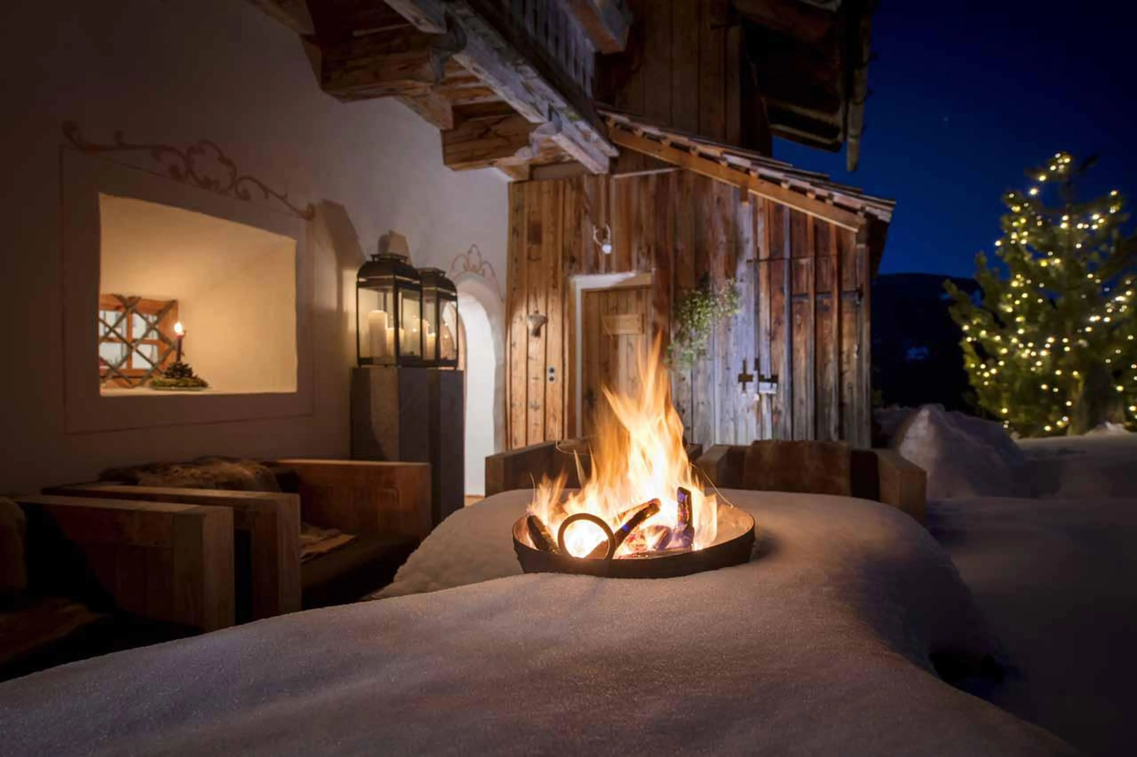 Terrace with firepit at San Lorenzo Mountain Lodge in Kronplatz