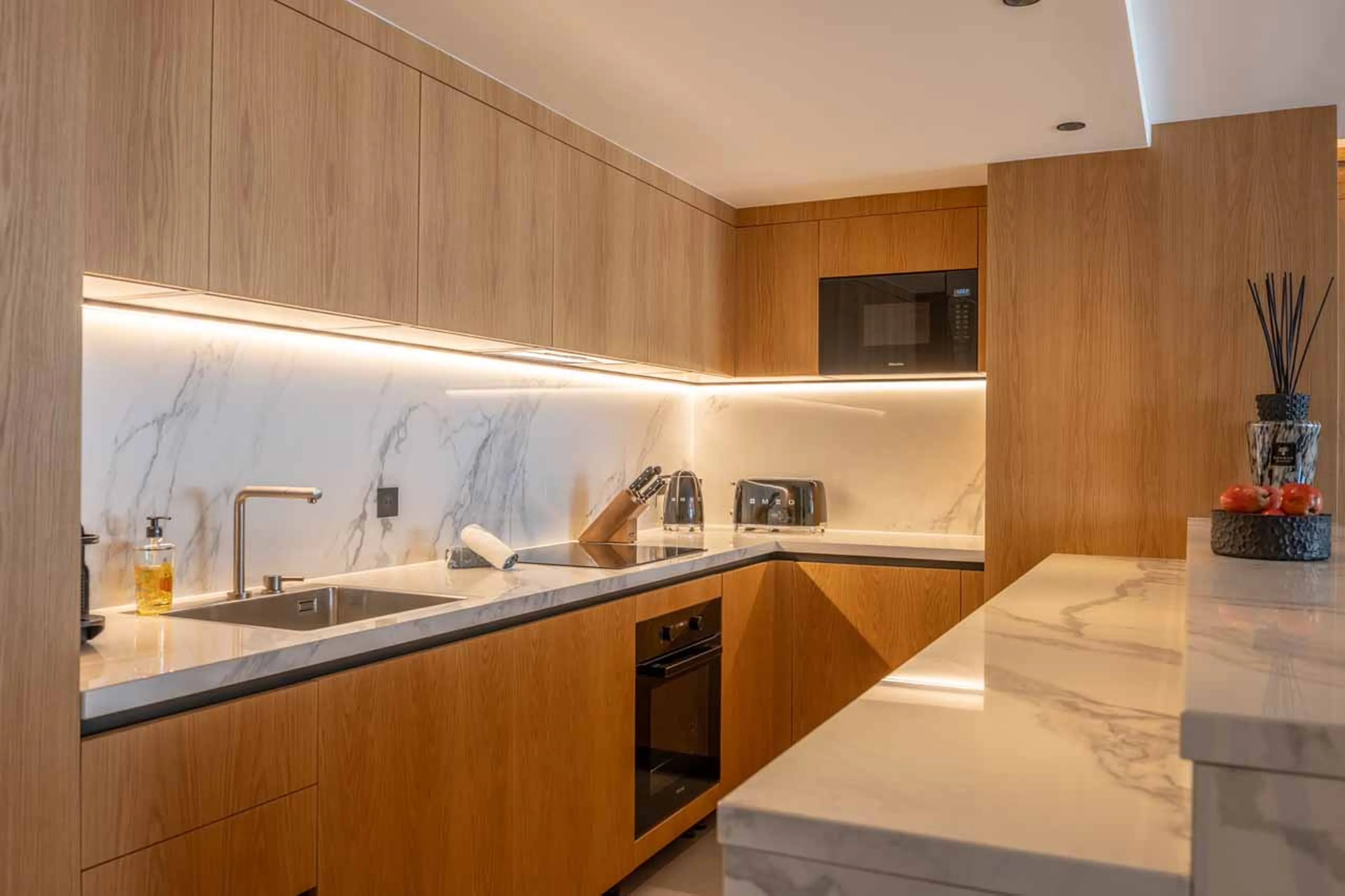 Kitchen with wooden facade and marble countertops in Sasha Apartment 3, Courchevel 1850