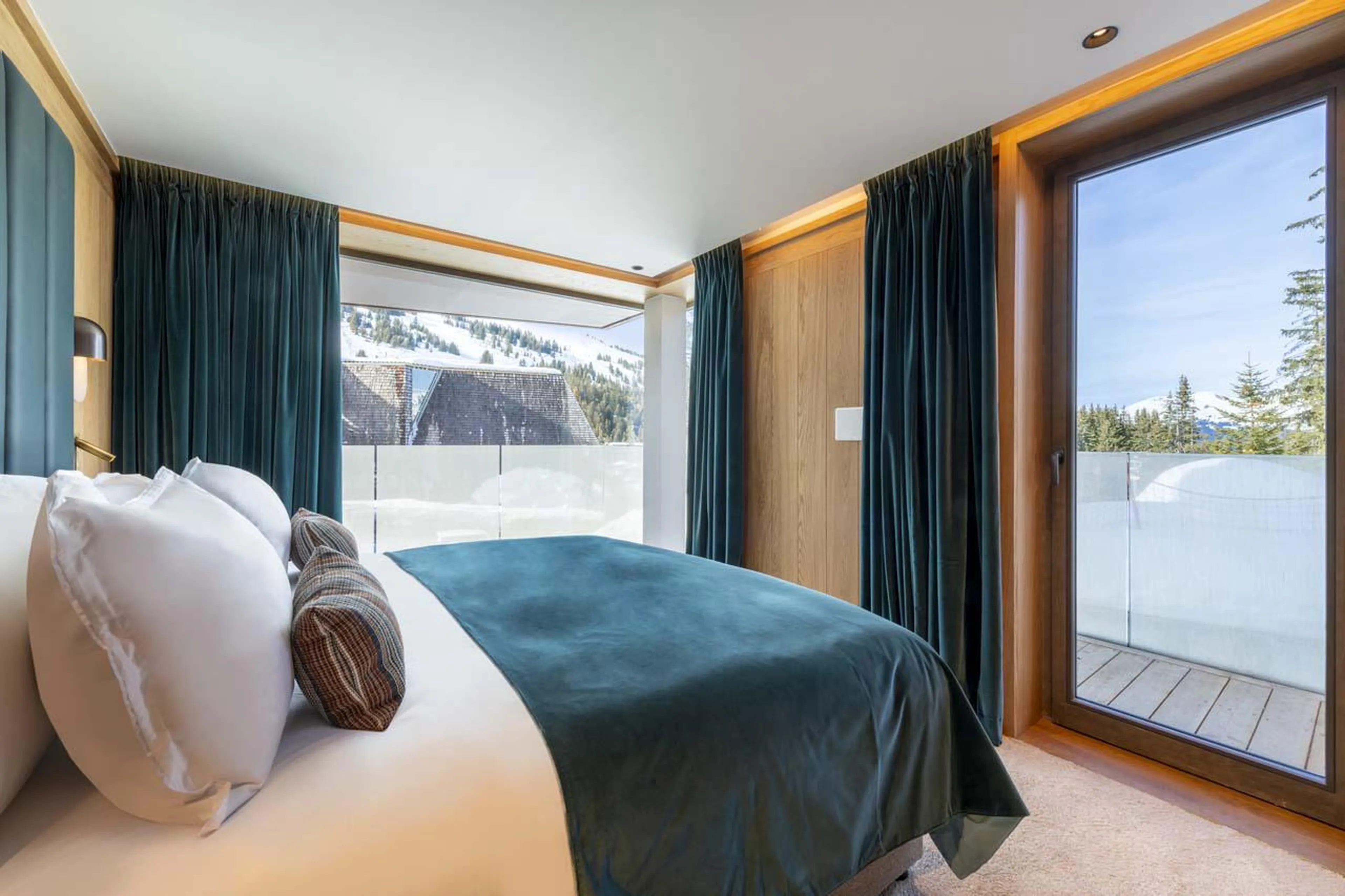 Bright bedroom with balcony access at Sasha Apartment 4 in Courchevel 1850