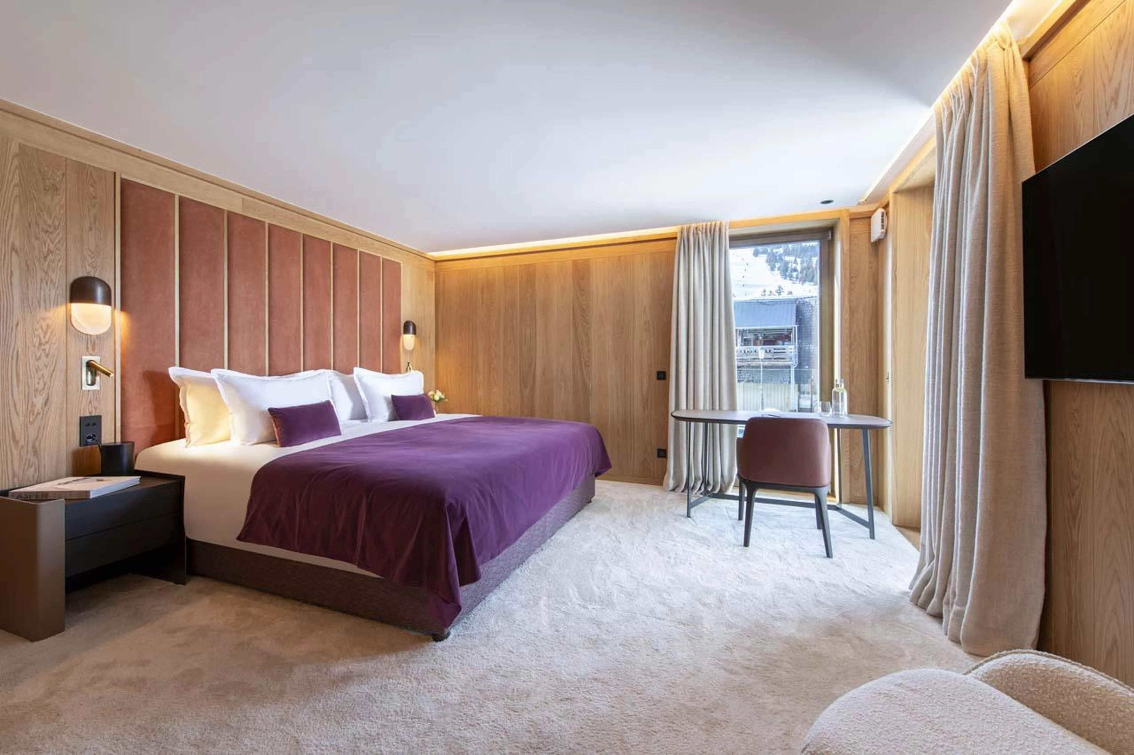 Double bedroom with desk, TV and en-suite shower room at Sasha Apartment 4 in Courchevel 1850