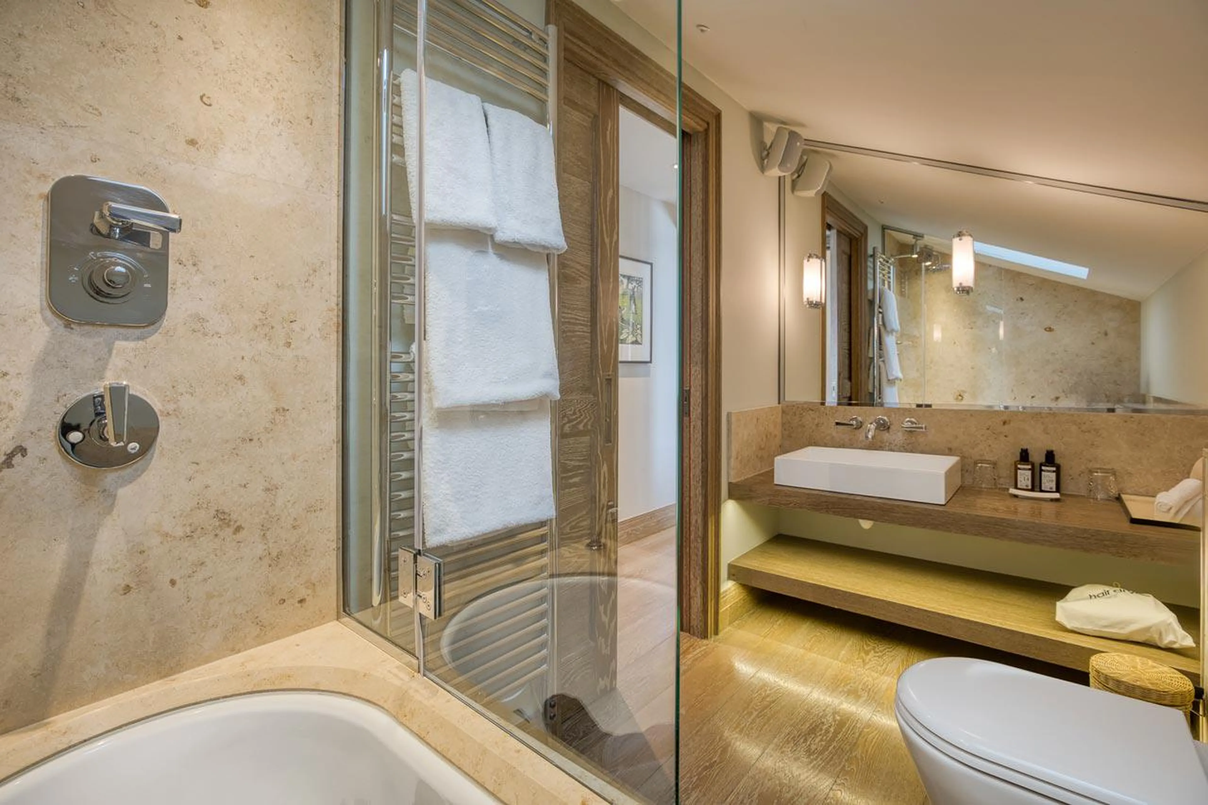 Bunk en-suite bathroom with bath, shower and double basin in Shemshak Lodge in Courchevel 1850