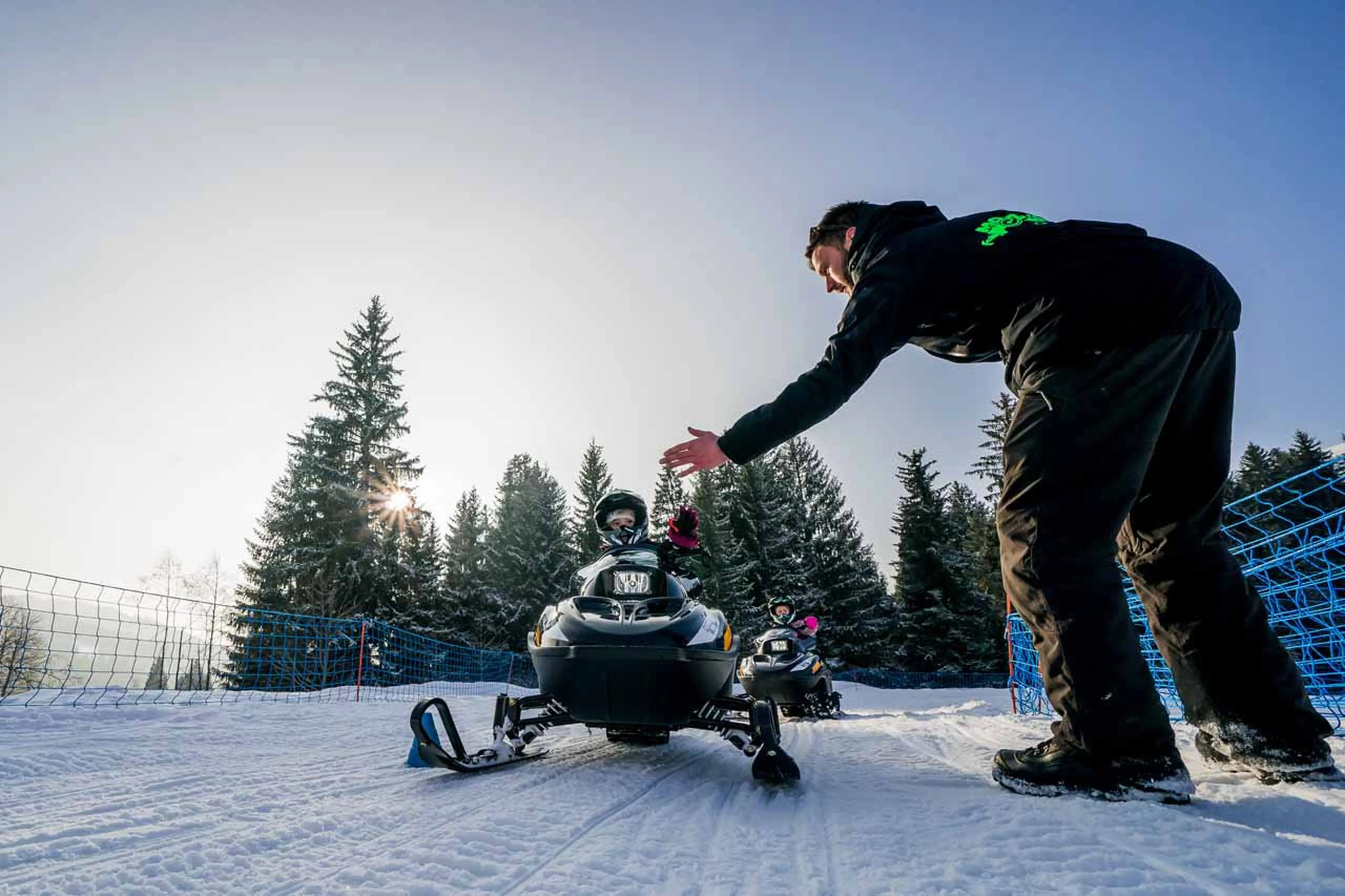 Child using an electric snowmobile in Les Gets