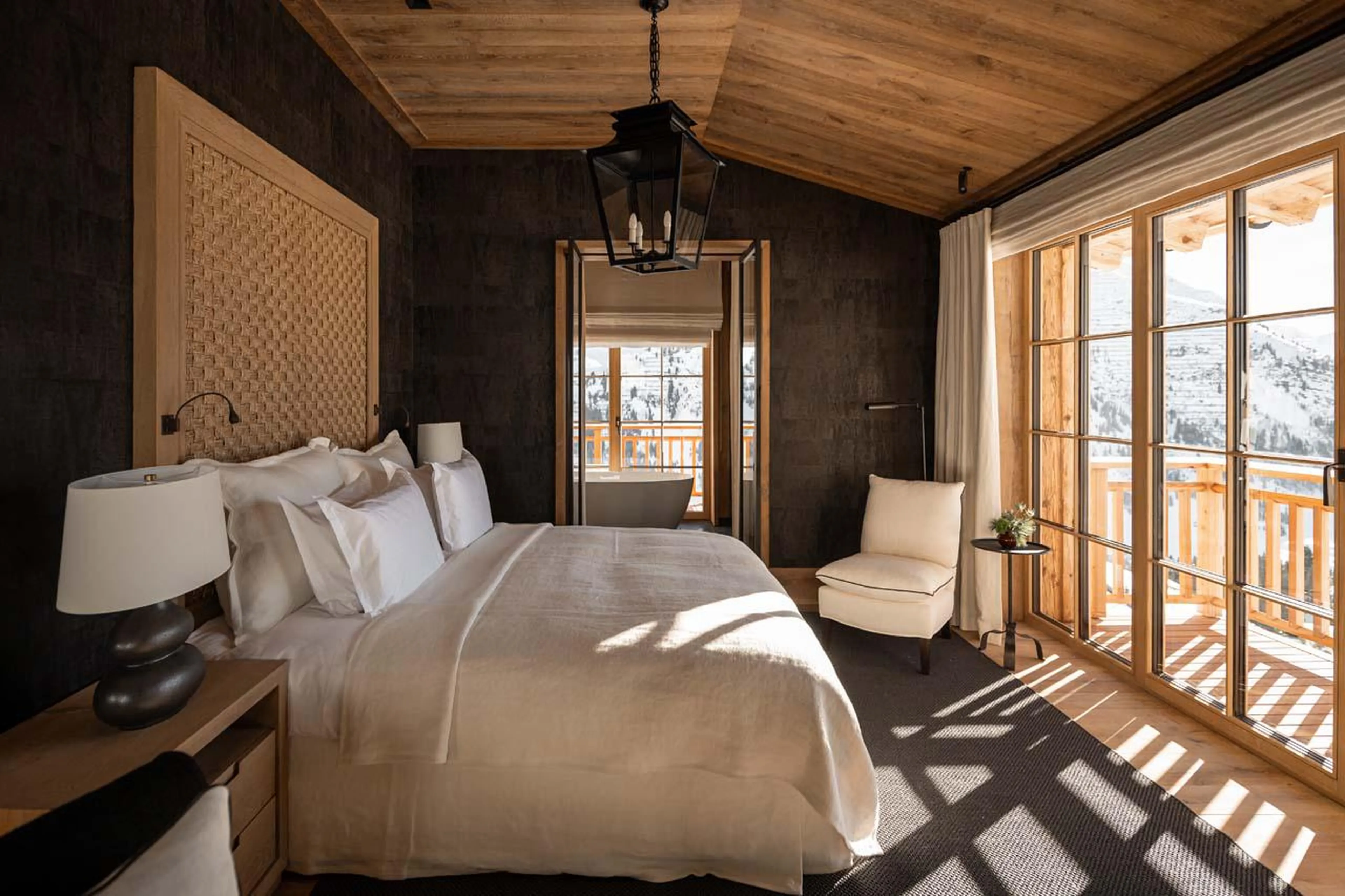 Double bedroom with private balcony, fireplace and en-suite bathroom at The Barn in Lech