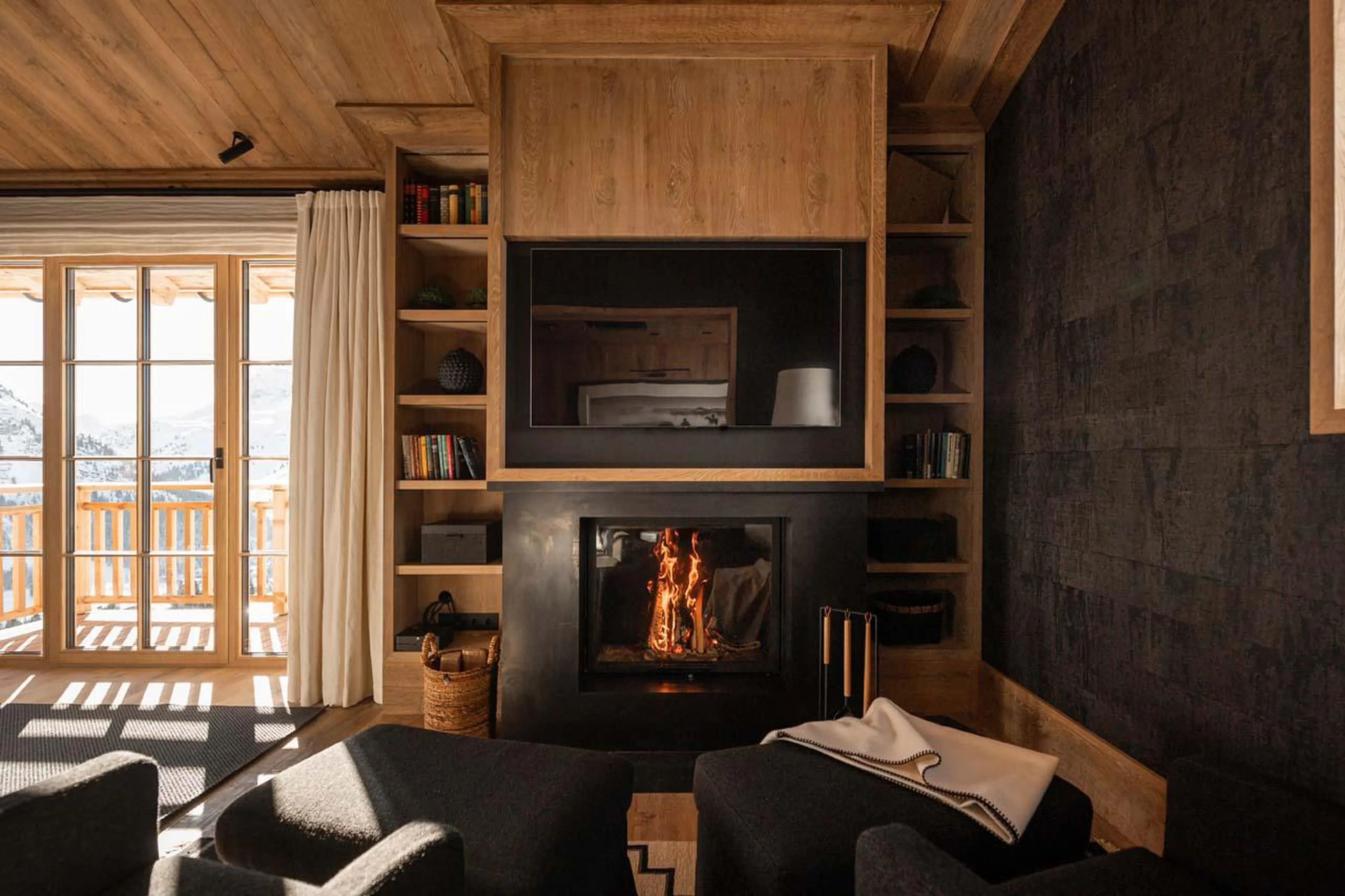 Double bedroom with fireplace and TV at The Barn in Lech