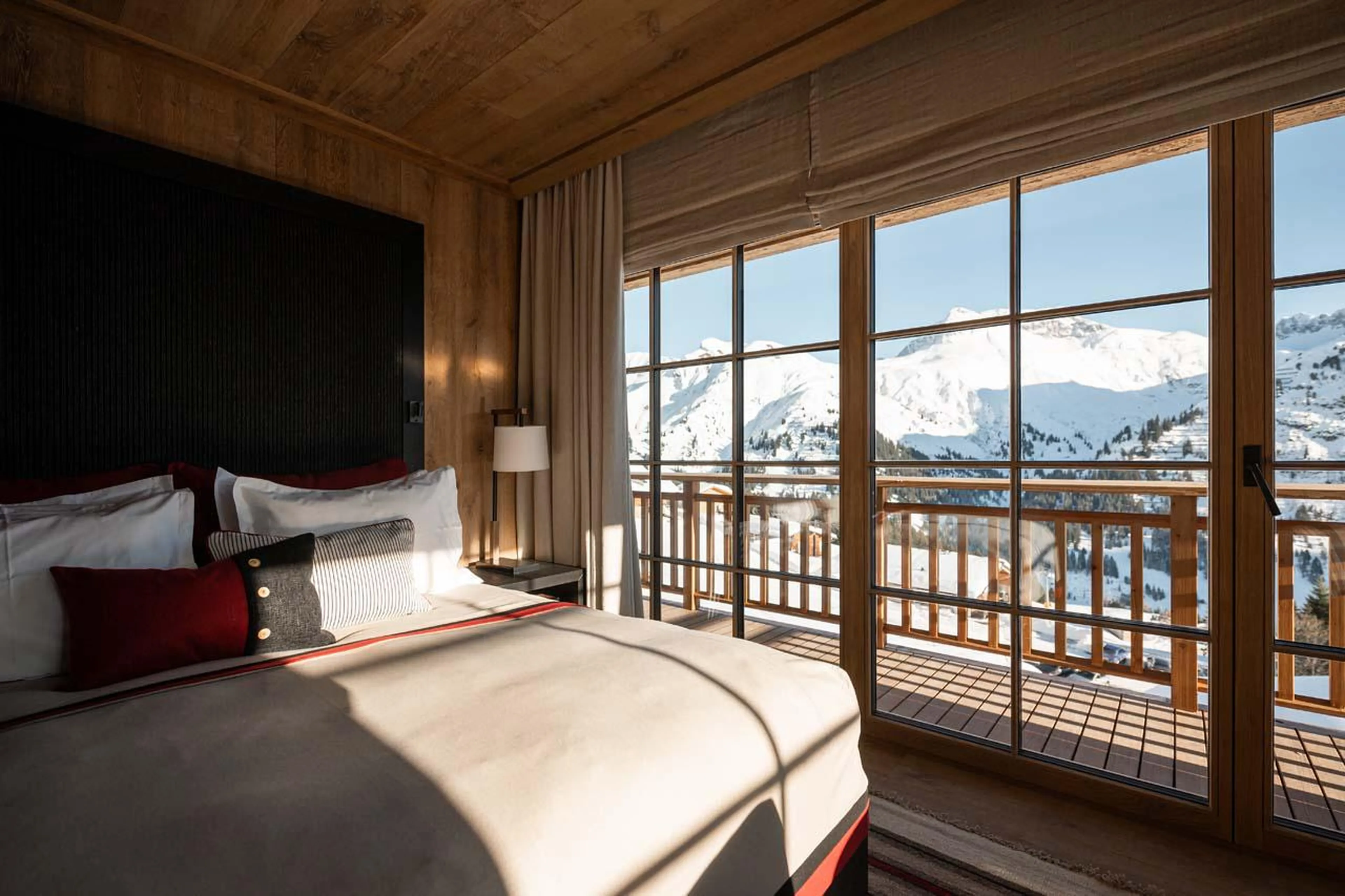 Double bedroom with access to shared balcony and en-suite shower room at The Barn in Lech