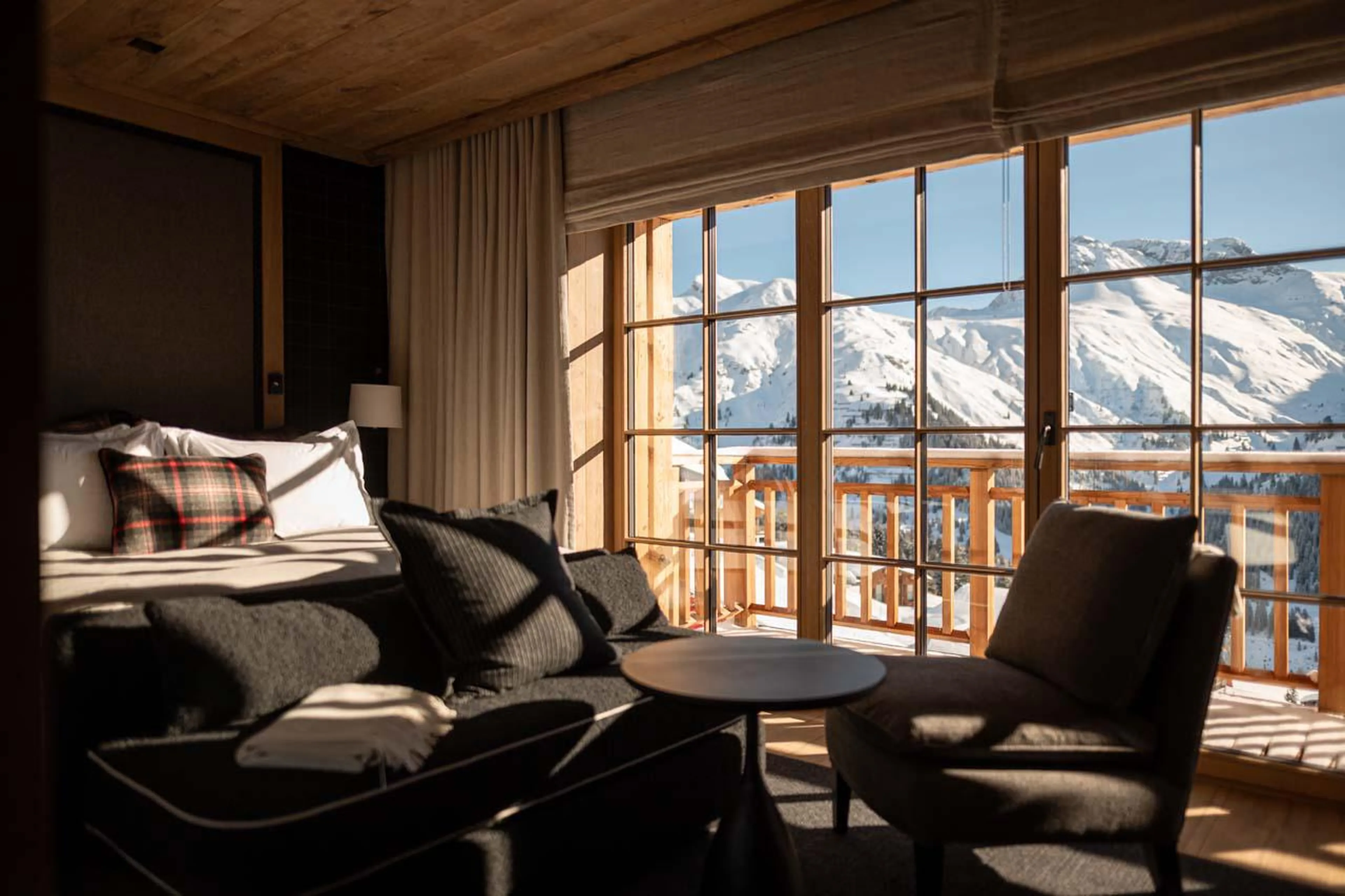 Double bedroom with access to a shared balcony and en-suite shower room at The Barn in Lech