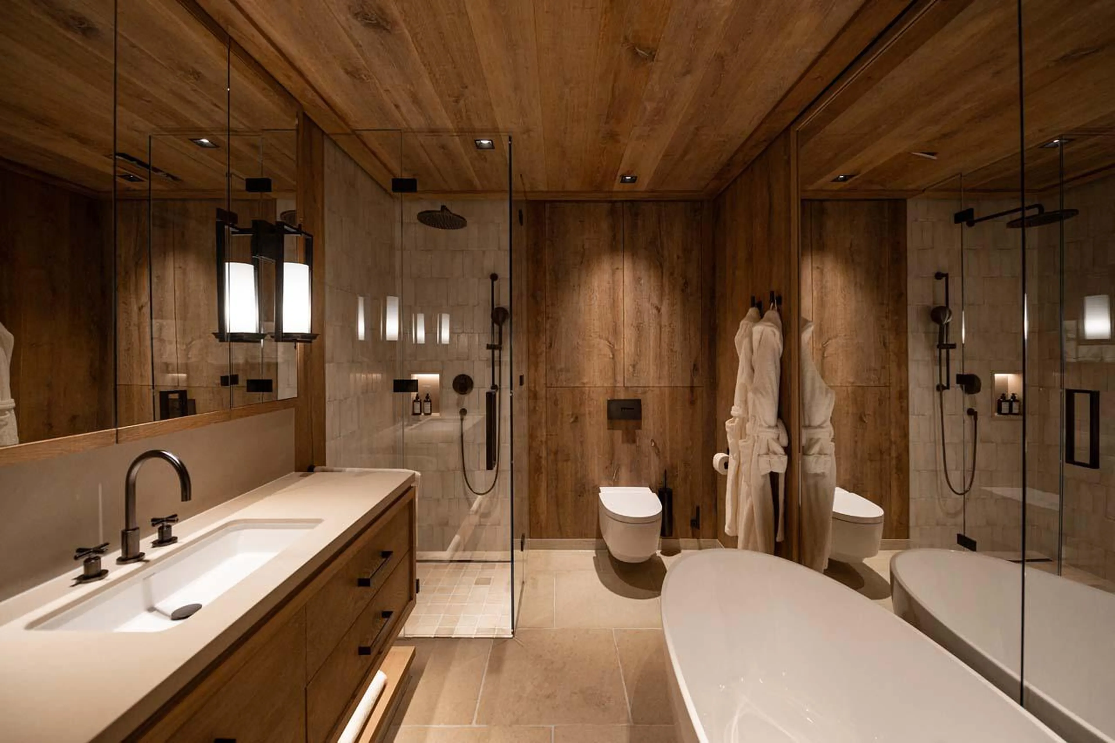 En-suite bathroom with bath and shower at The Barn in Lech