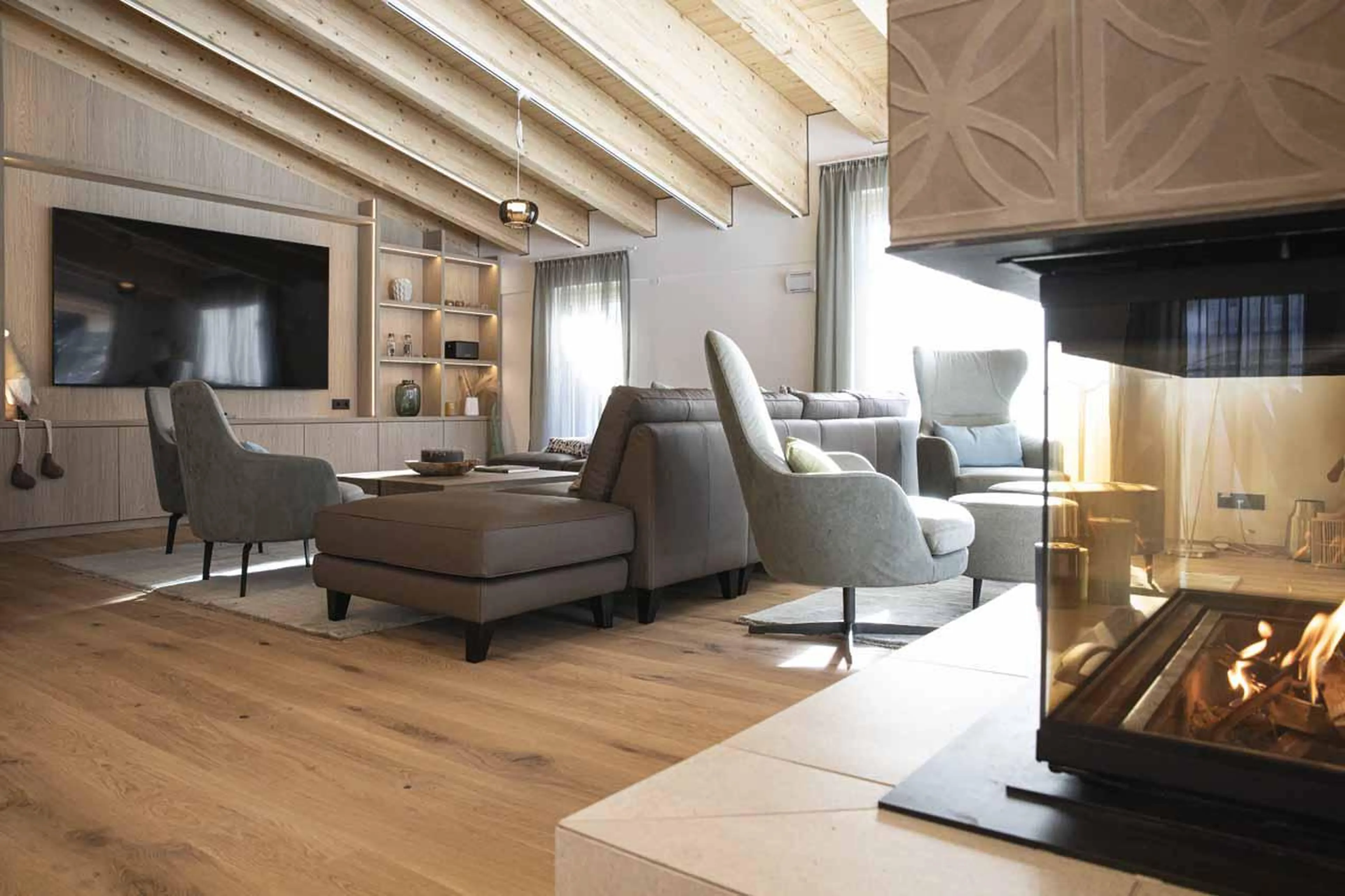 Sofas and armchairs in front of fireplace and TV in The Lodge @ 47