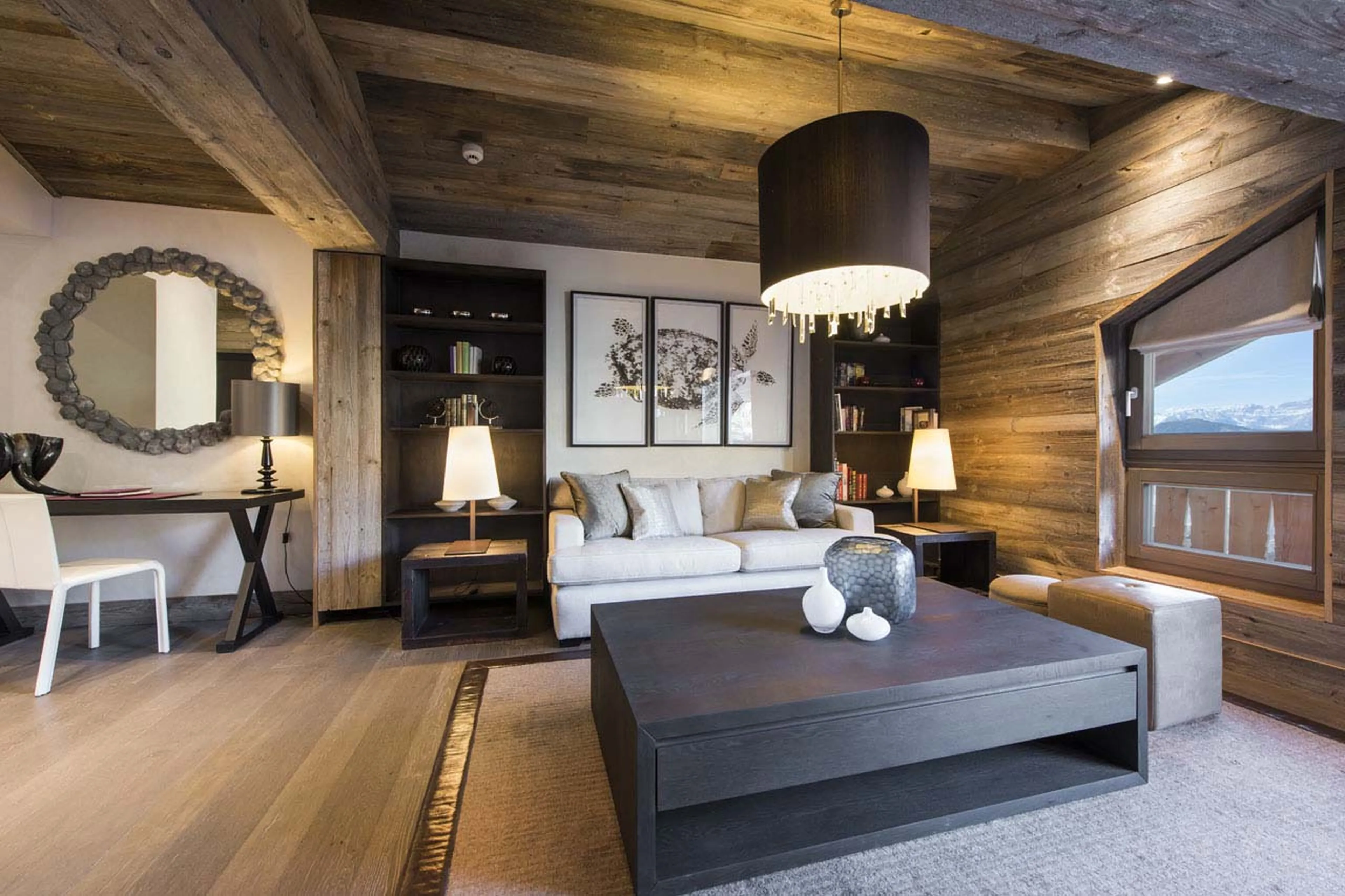 Sofa and desk in lounge area of master bedroom in he Lodge in Verbier