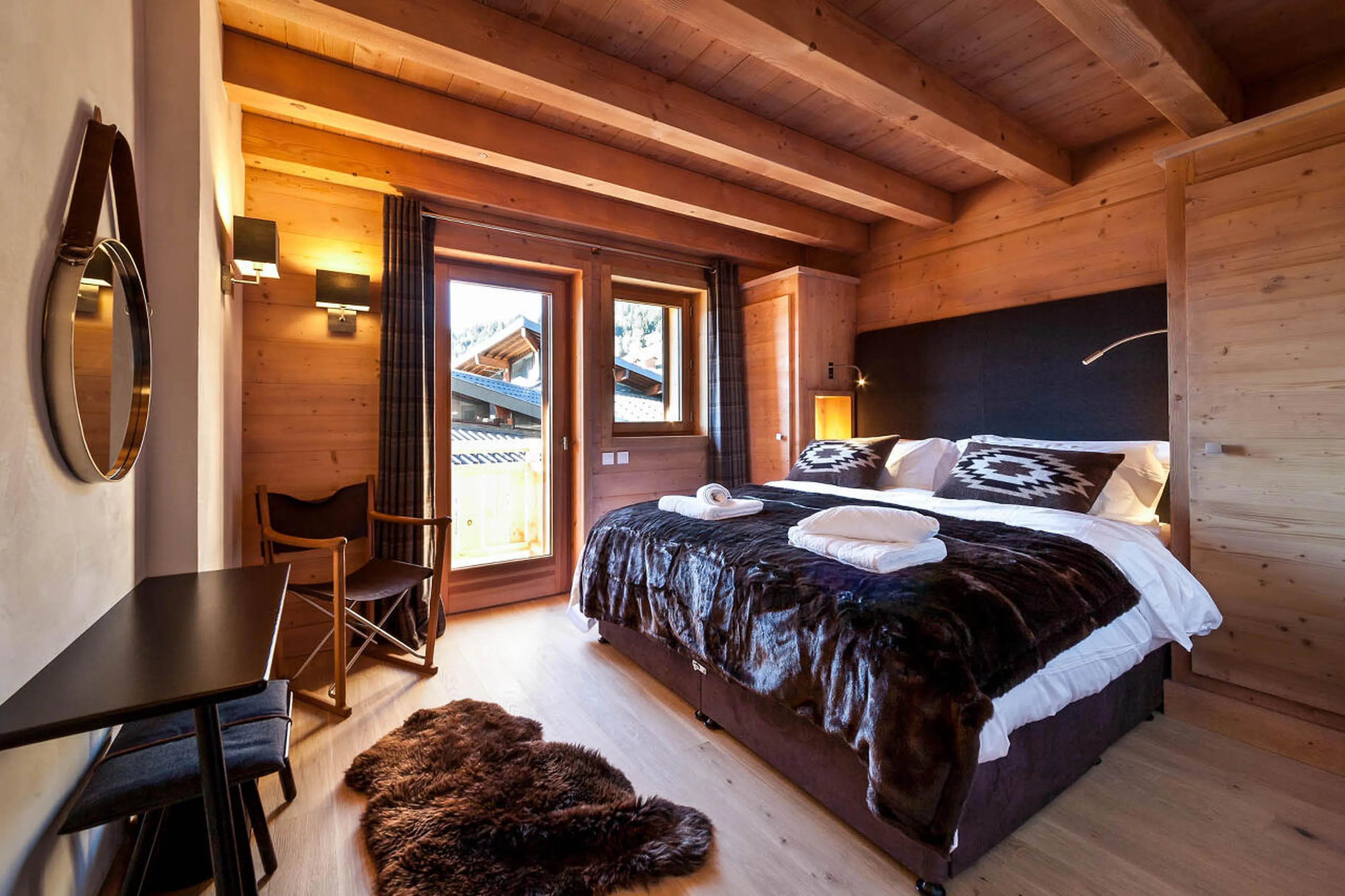 Super king-size bed in bedroom open to balcony in The Penthouse, Les Gets