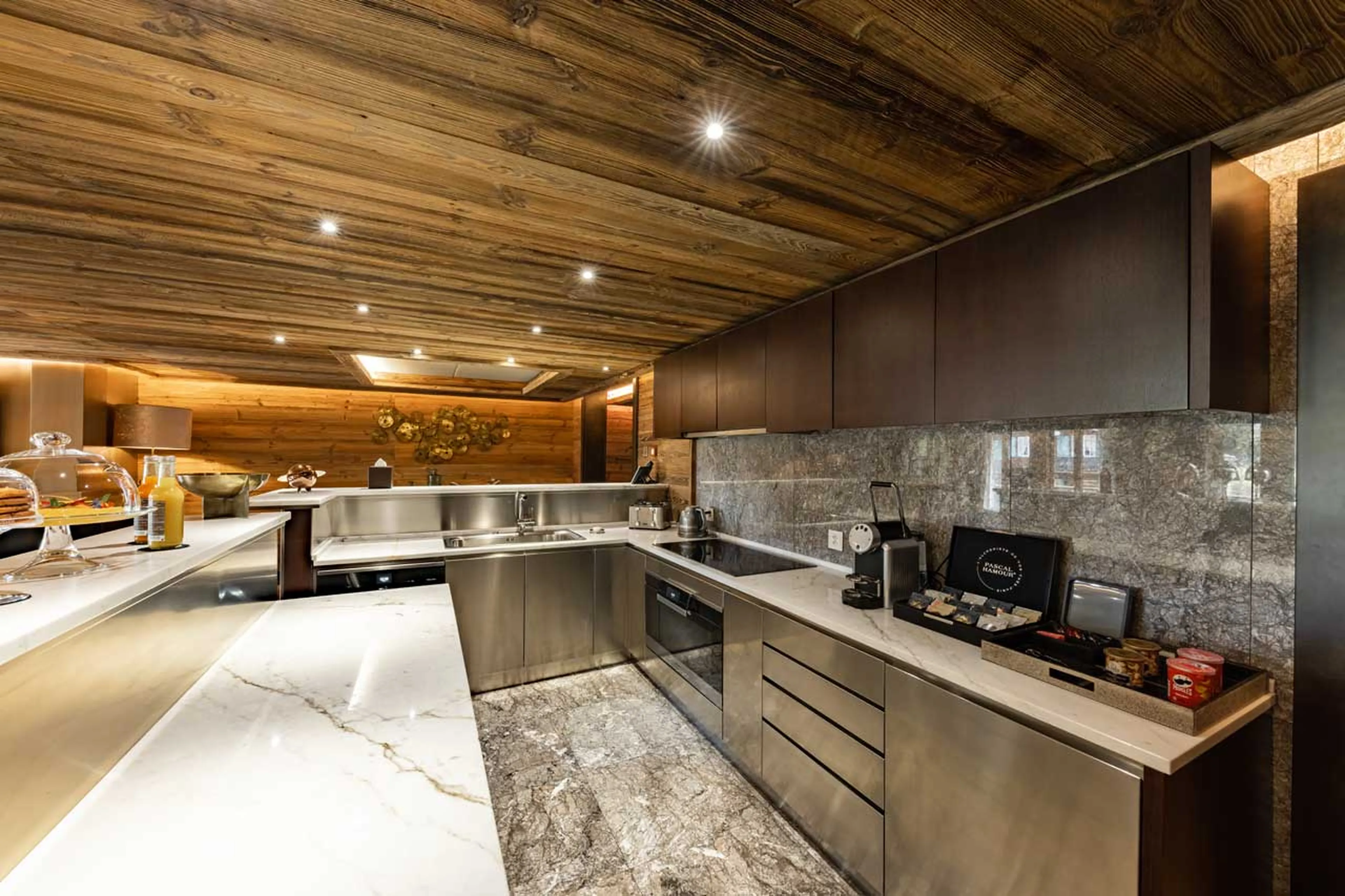 Kitchen with breakfast bar at Ultima Gstaad 4BR Residence in Gstaad