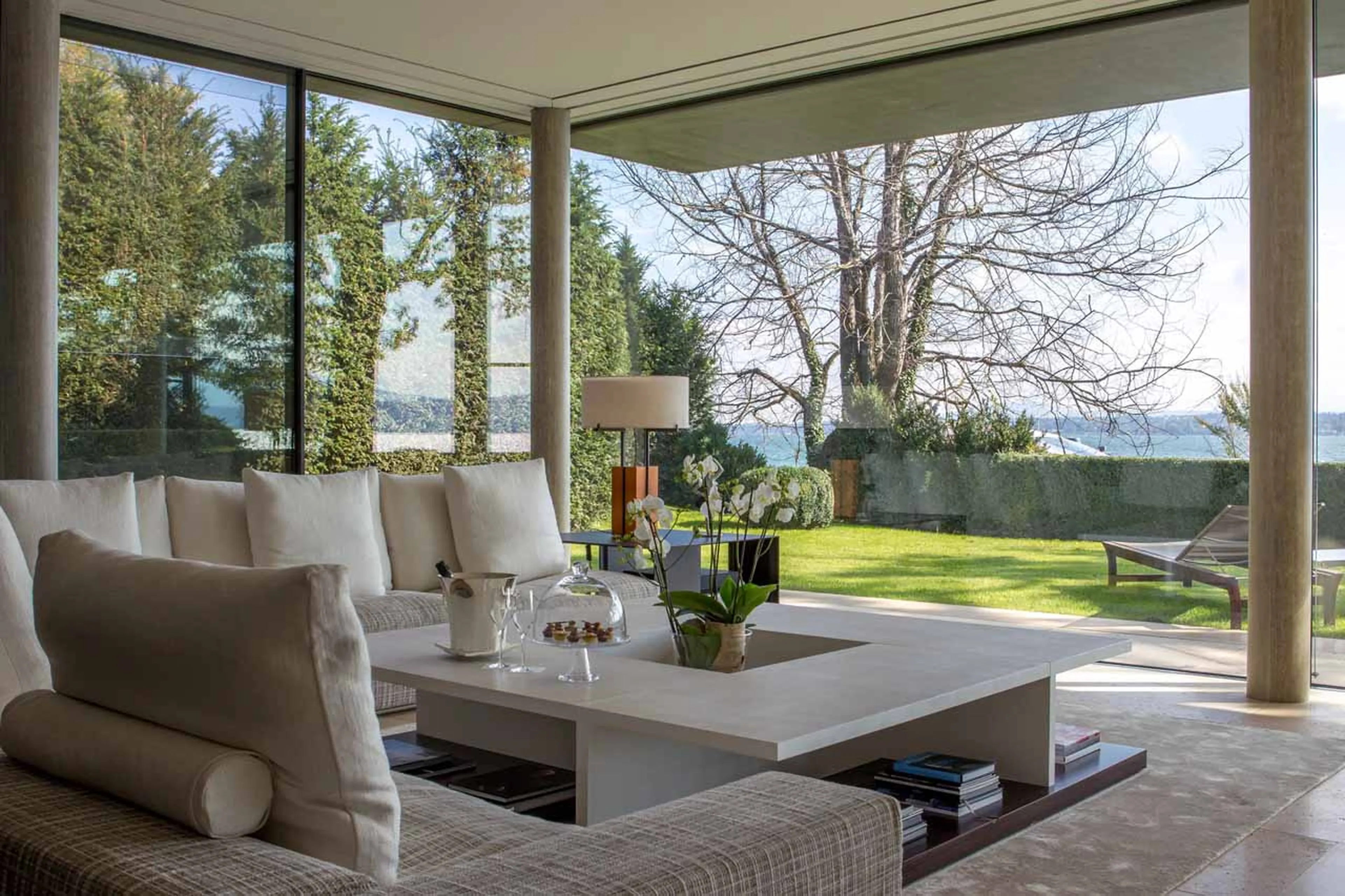 Glass-fronted living area at Villa du Lac in Geneva