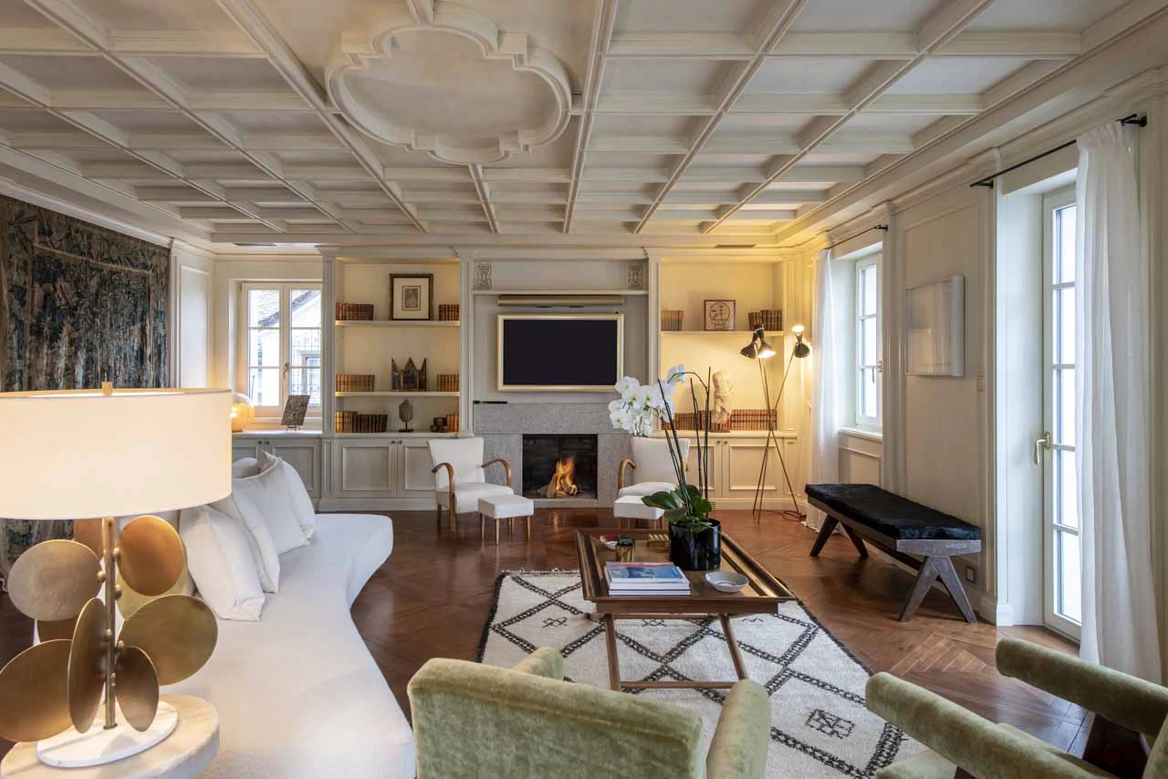 Sofas and coffee table in front of fireplace in Villa Erica 1, St Moritz
