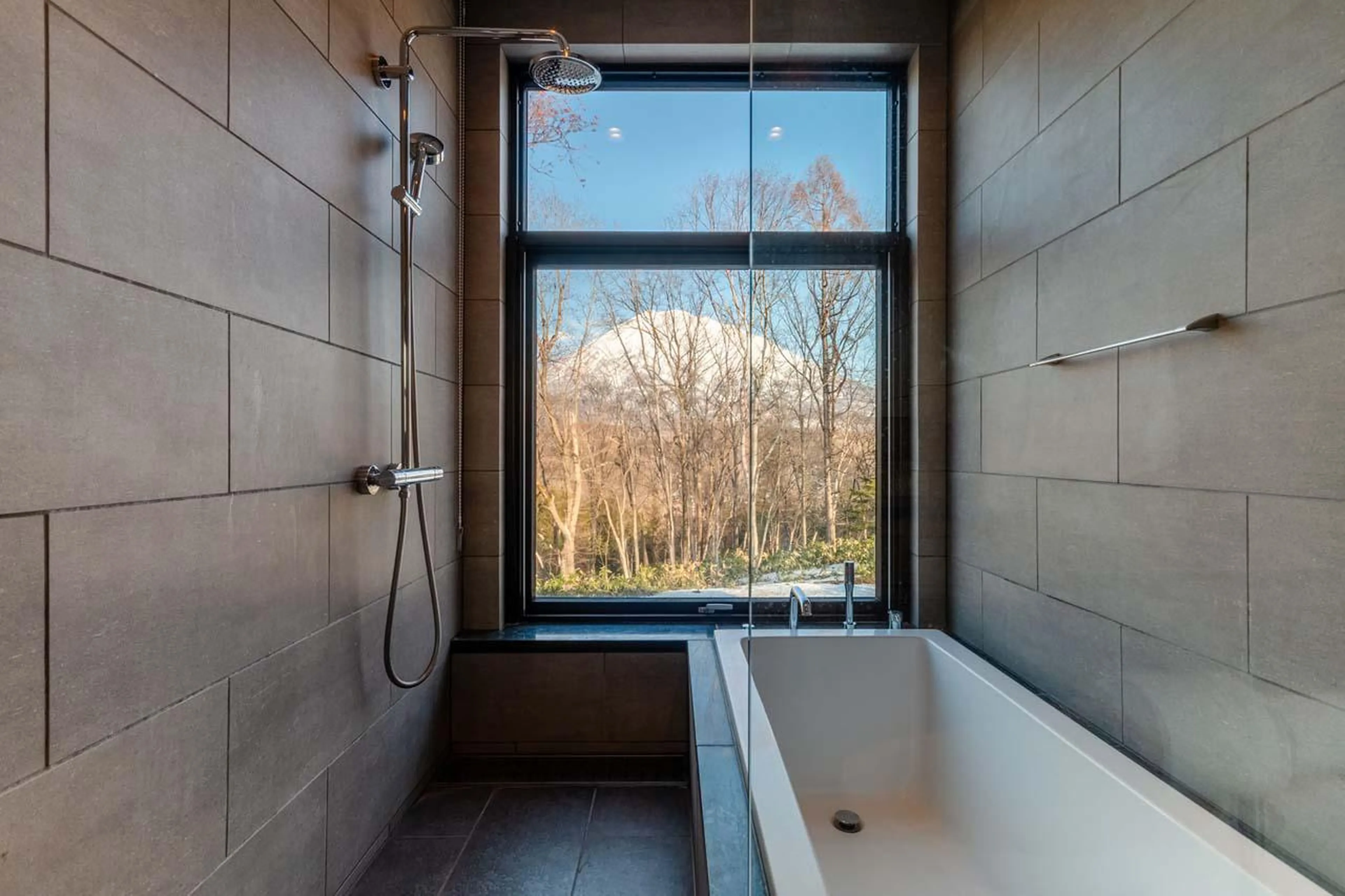 En-suite bathroom with bath and shower at Yanagi House in Niseko